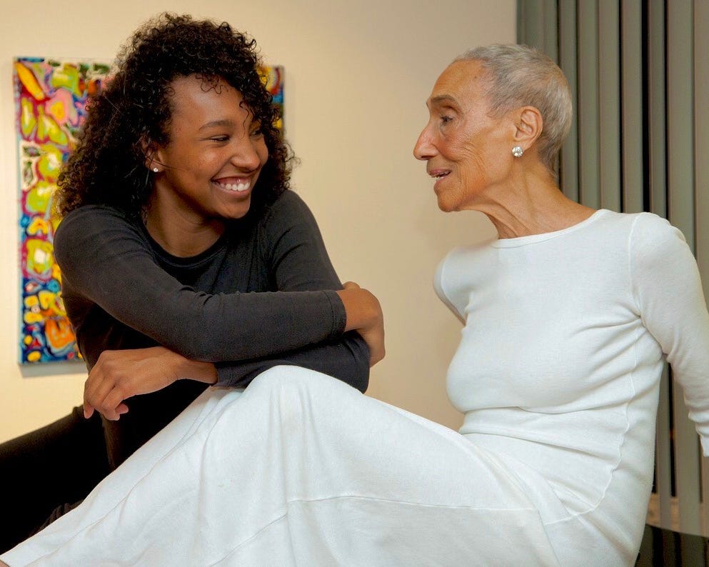 Aliya and Millie together, with Millie in white.