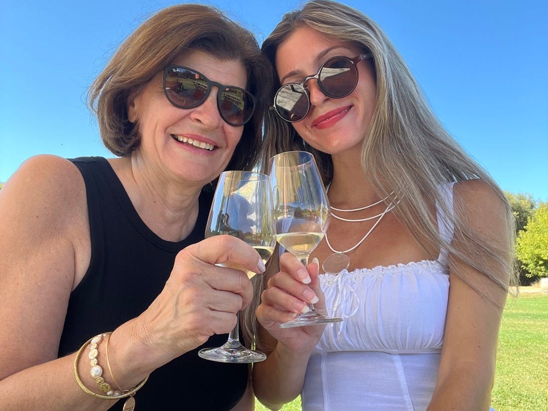 Author Alexa Mellardo and her mom smiling with wine glasses