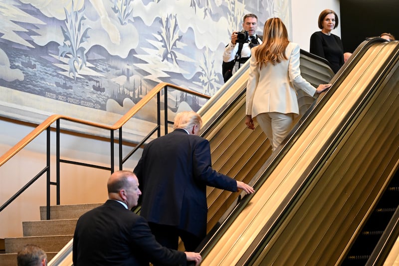 Donald Trump (C) and first lady Melania Trump.