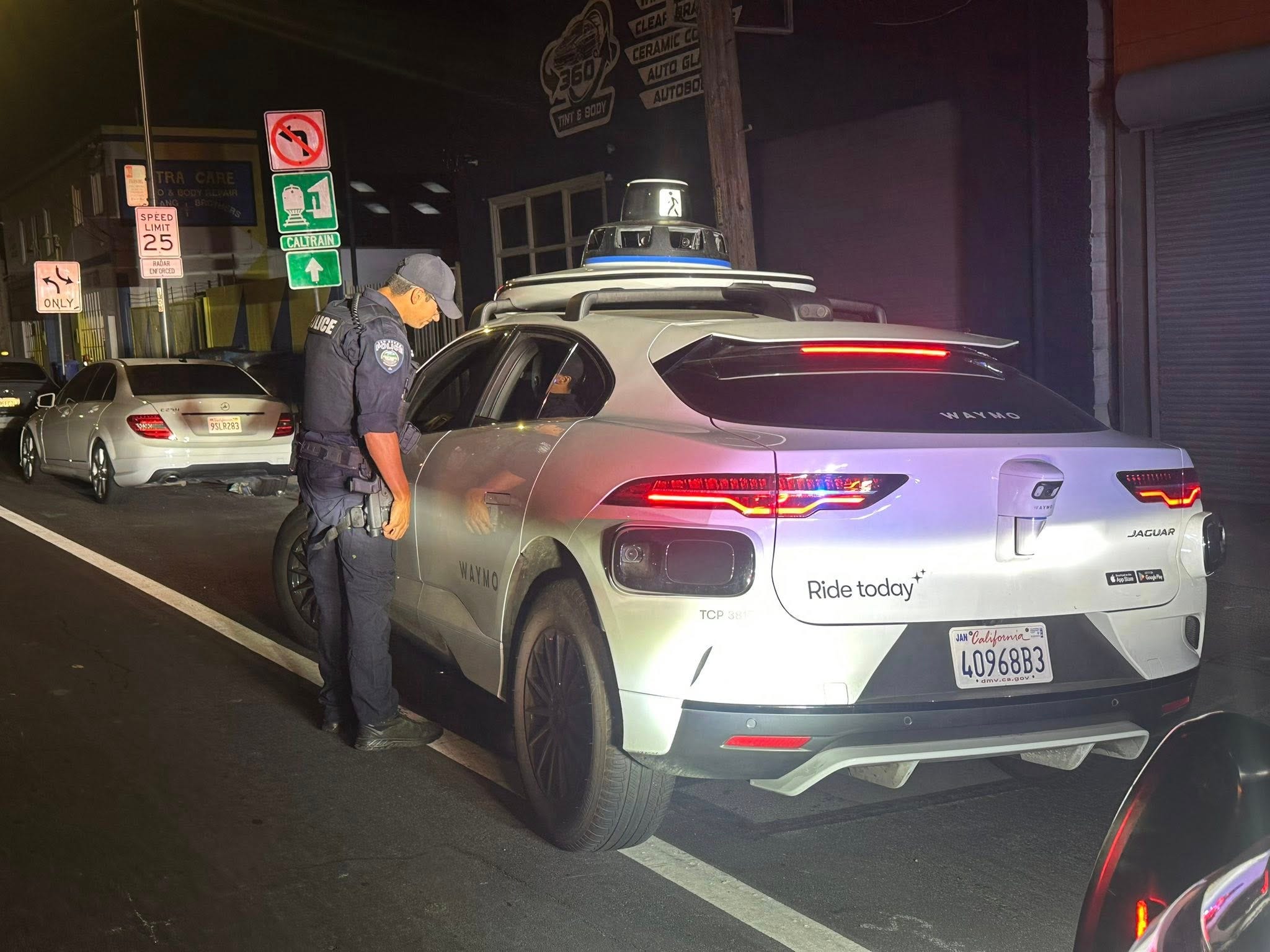The Waymo car that has been pulled over by a police officer.