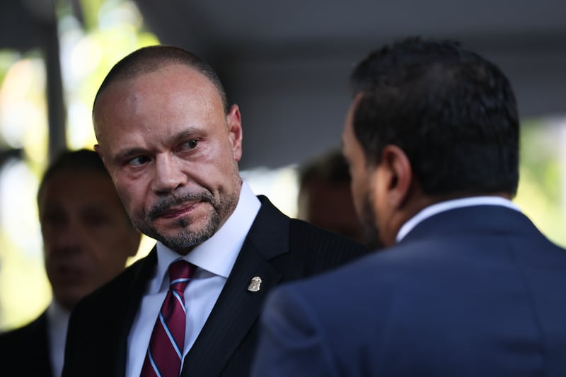 Dan Bongino, Deputy Director of the FBI, (L) speaks with Kash Patel, the FBI director, as they attend the annual 9/11 Commemoration Ceremony at the National 9/11 Memorial and Museum on September 11, 2025 in New York City. Government officials joined family, friends, and first responders as they gathered at Ground Zero, honoring the lives of the victims on the 24th anniversary of the terror attacks of September 11, 2001, at the World Trade Center.