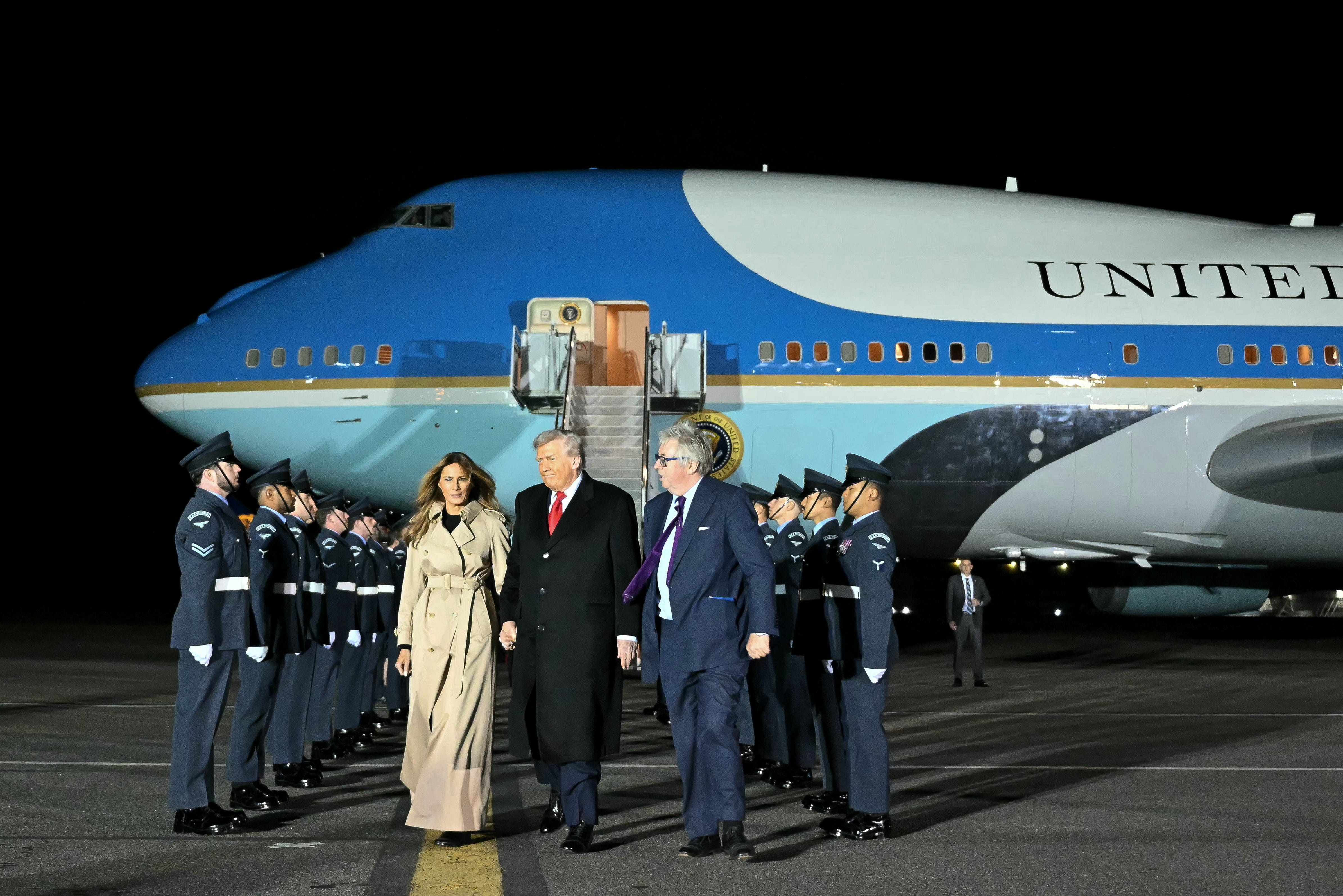 US President Donald Trump (C) and US First Lady Melania Trump disembark from Air Force One after landing at Stansted Airport, eastern England, on September 16, 2025
