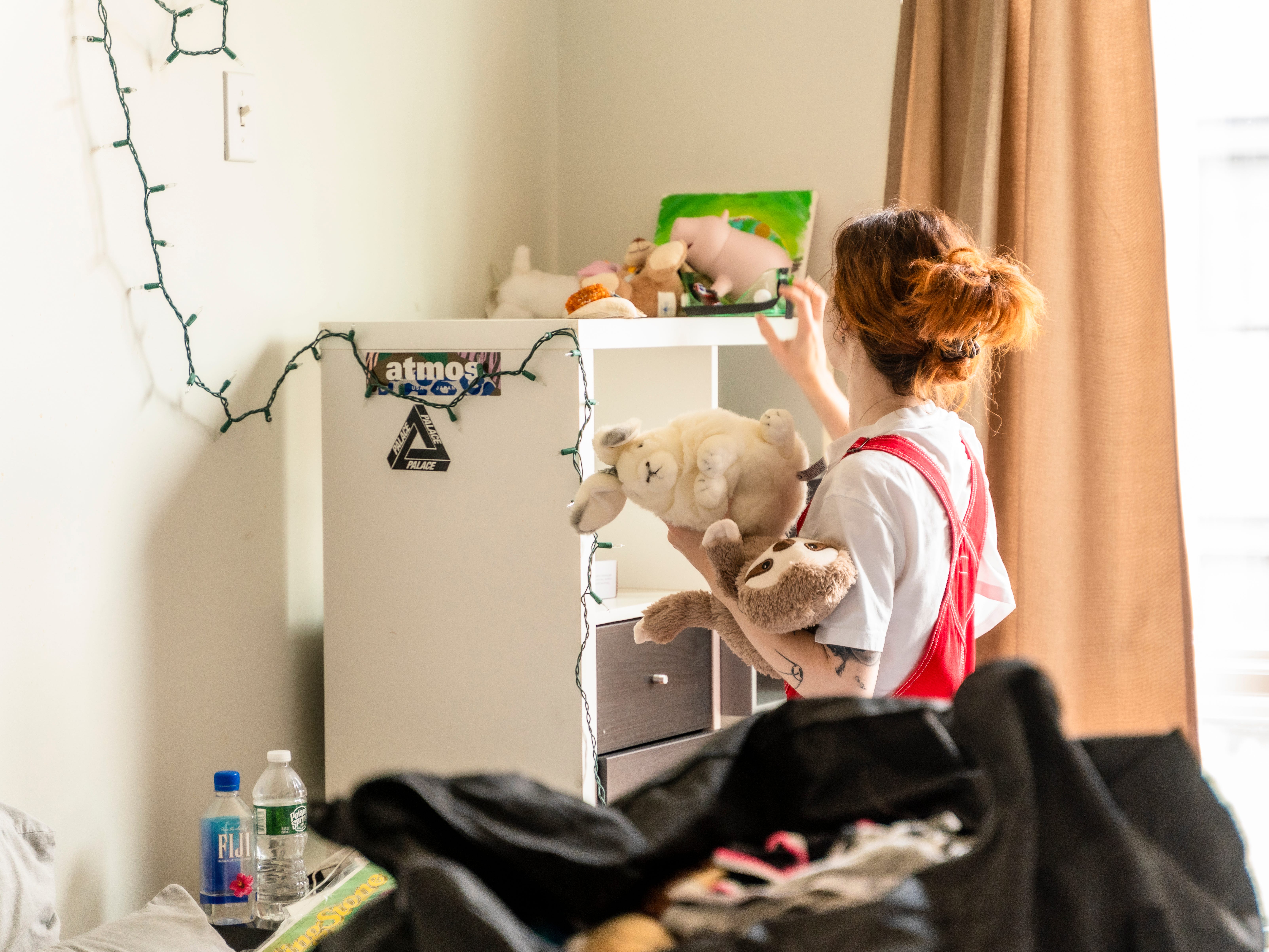 A woman packing up her childhood bedroom.