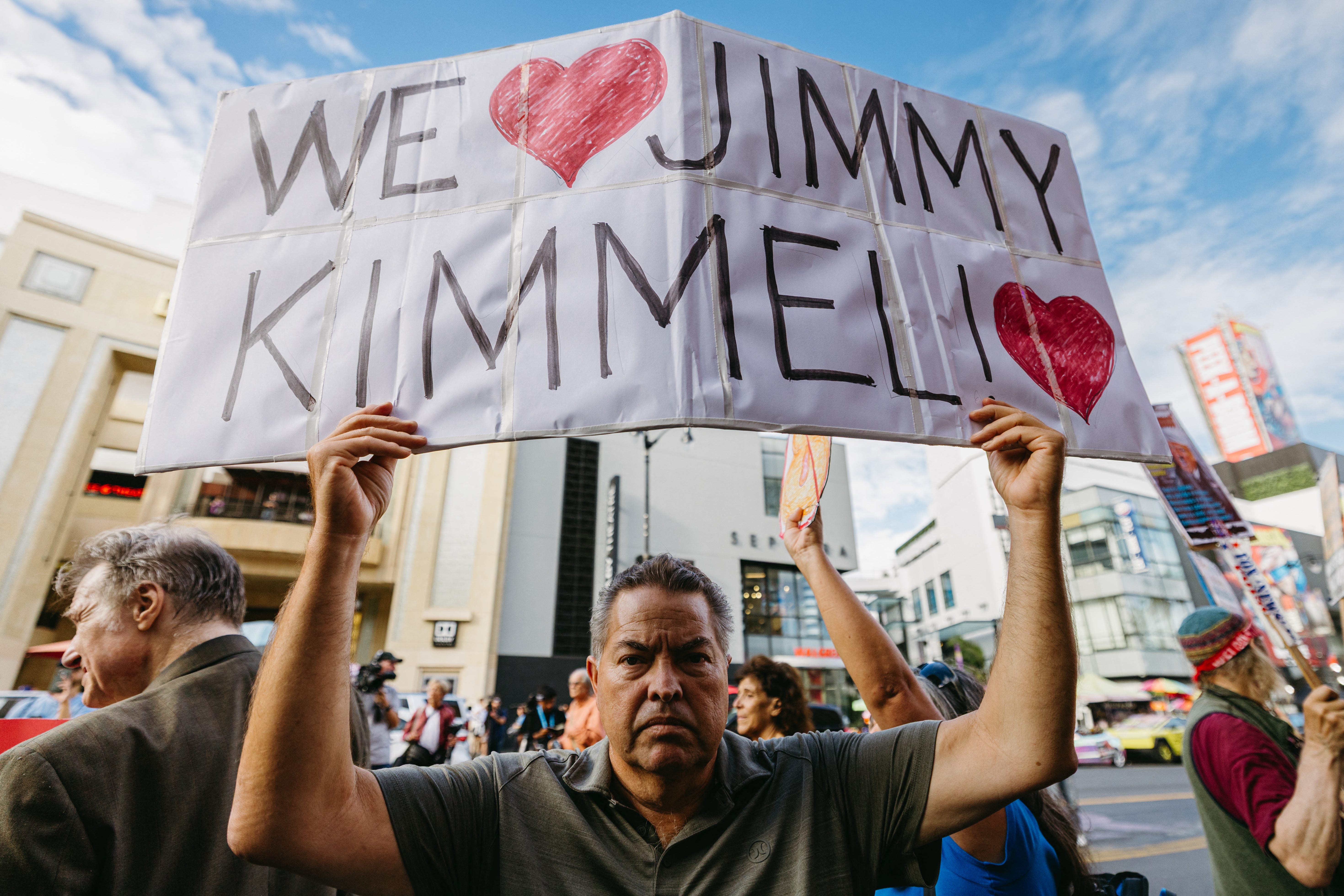 A protester at El Capitan Theatre on Hollywood Boulevard is pictured.