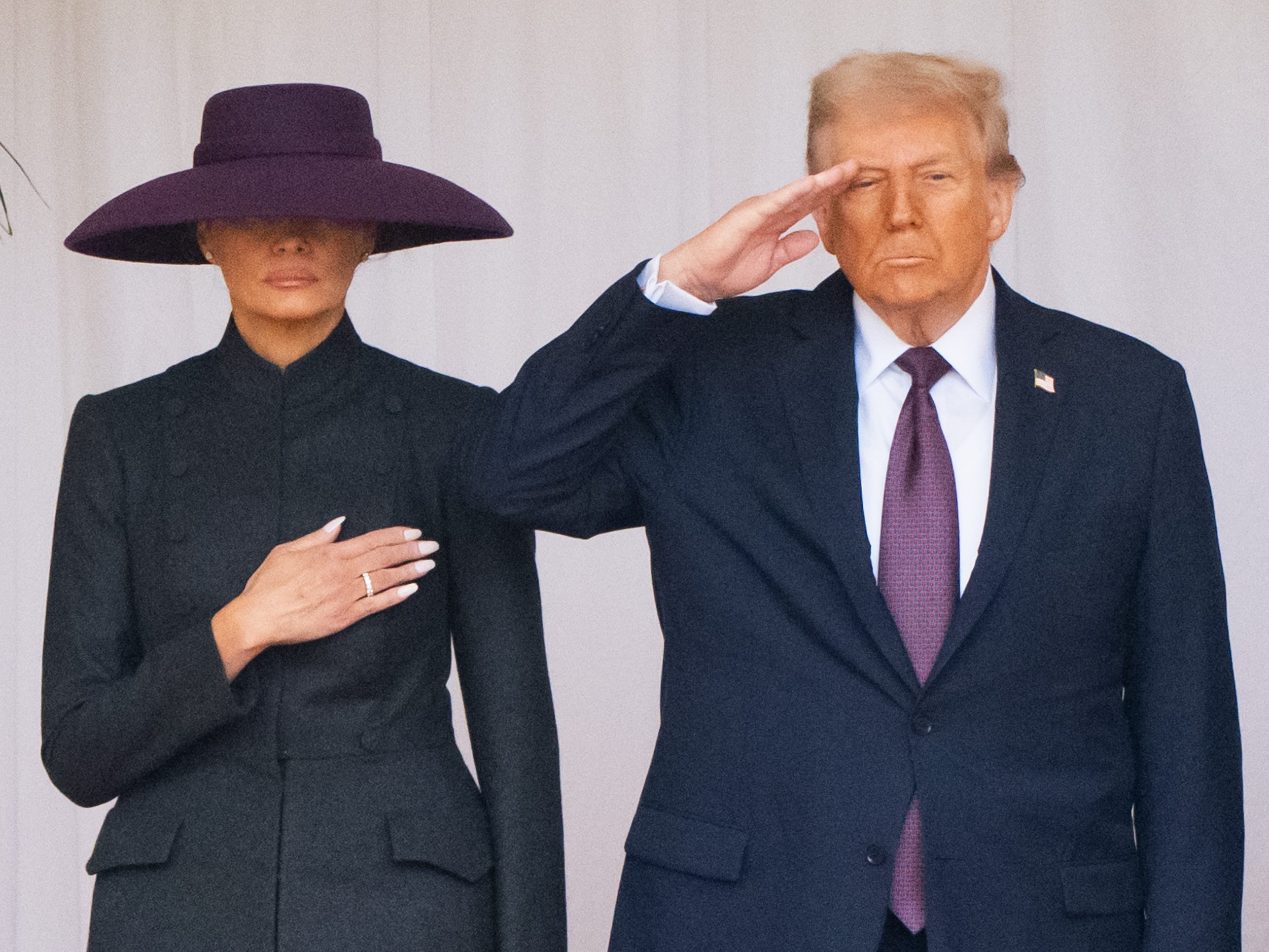 Melania Trump and Donald Trump in matching purple accessories.