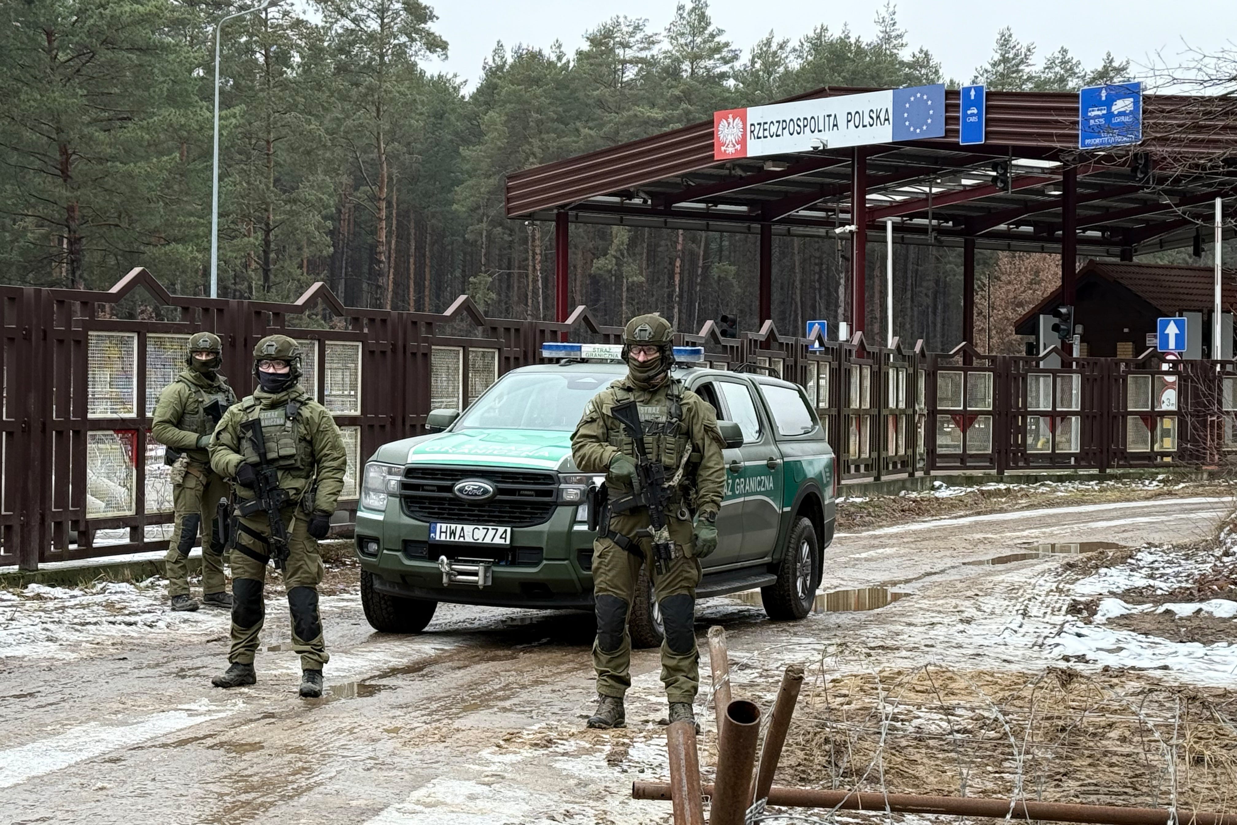 Polish border guards stand at a crossing to the border with Belarus, which will be closed in 2023 for security reasons.