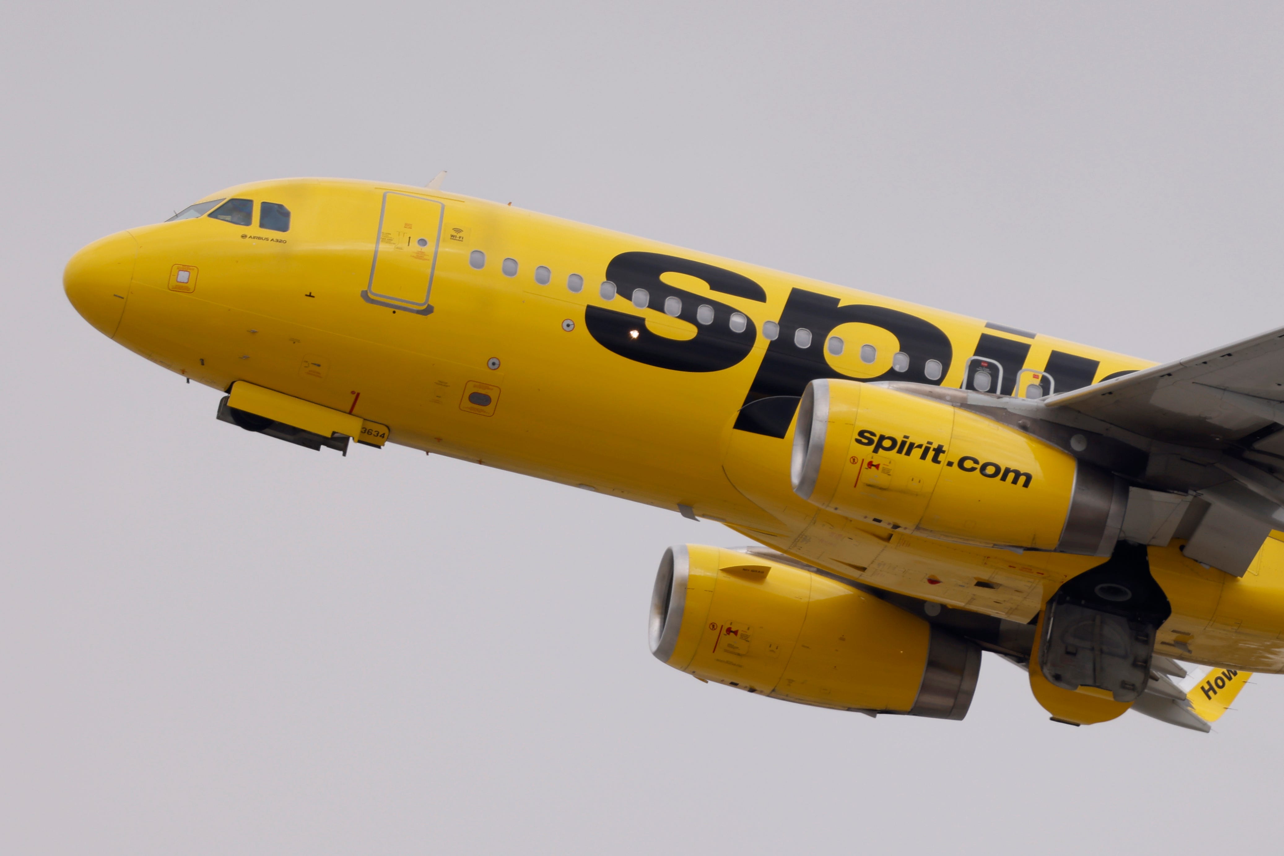 A yellow Spirit Airlines plane taking off.