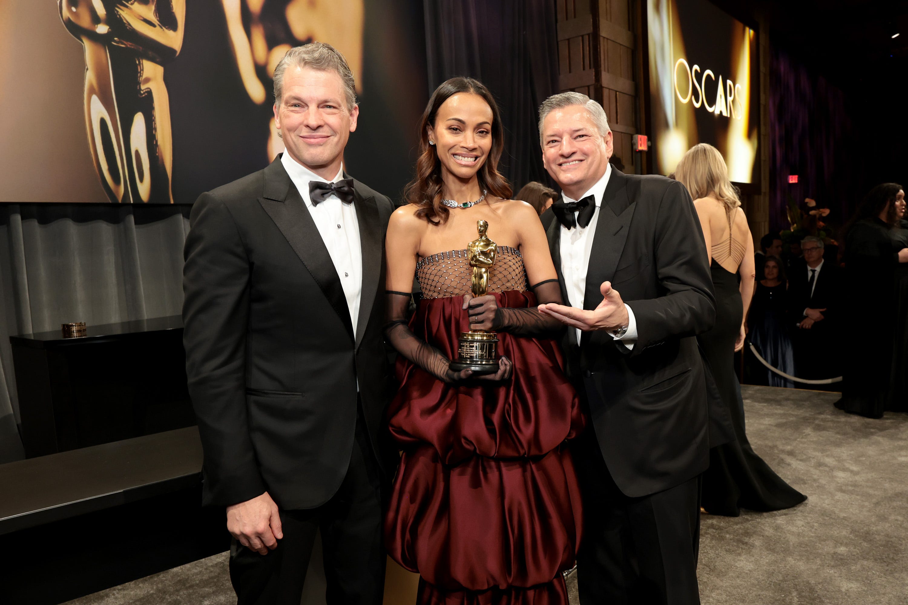 Greg Peters and Ted Sarandos with Zoe Saldaña