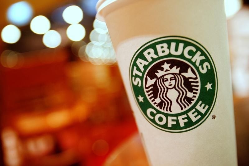 A cup of Starbucks coffee sits on a table in a cafe in central Hong Kong January 16, 2011. REUTERS/Joel Boh/File Photo