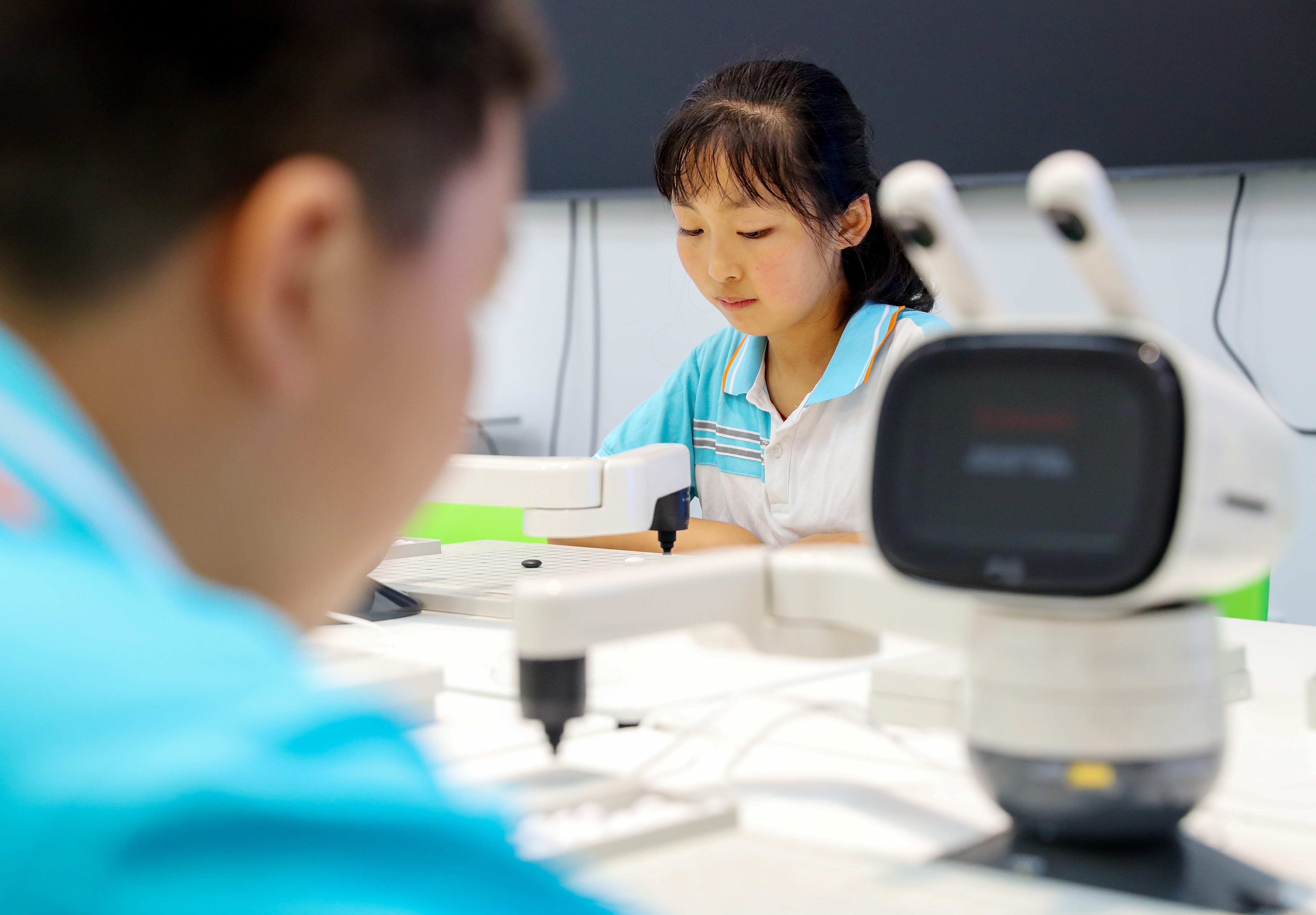 Middle school students play with robots at an educational facility in Laixi, east China's Shandong province, on September 9, 2025.