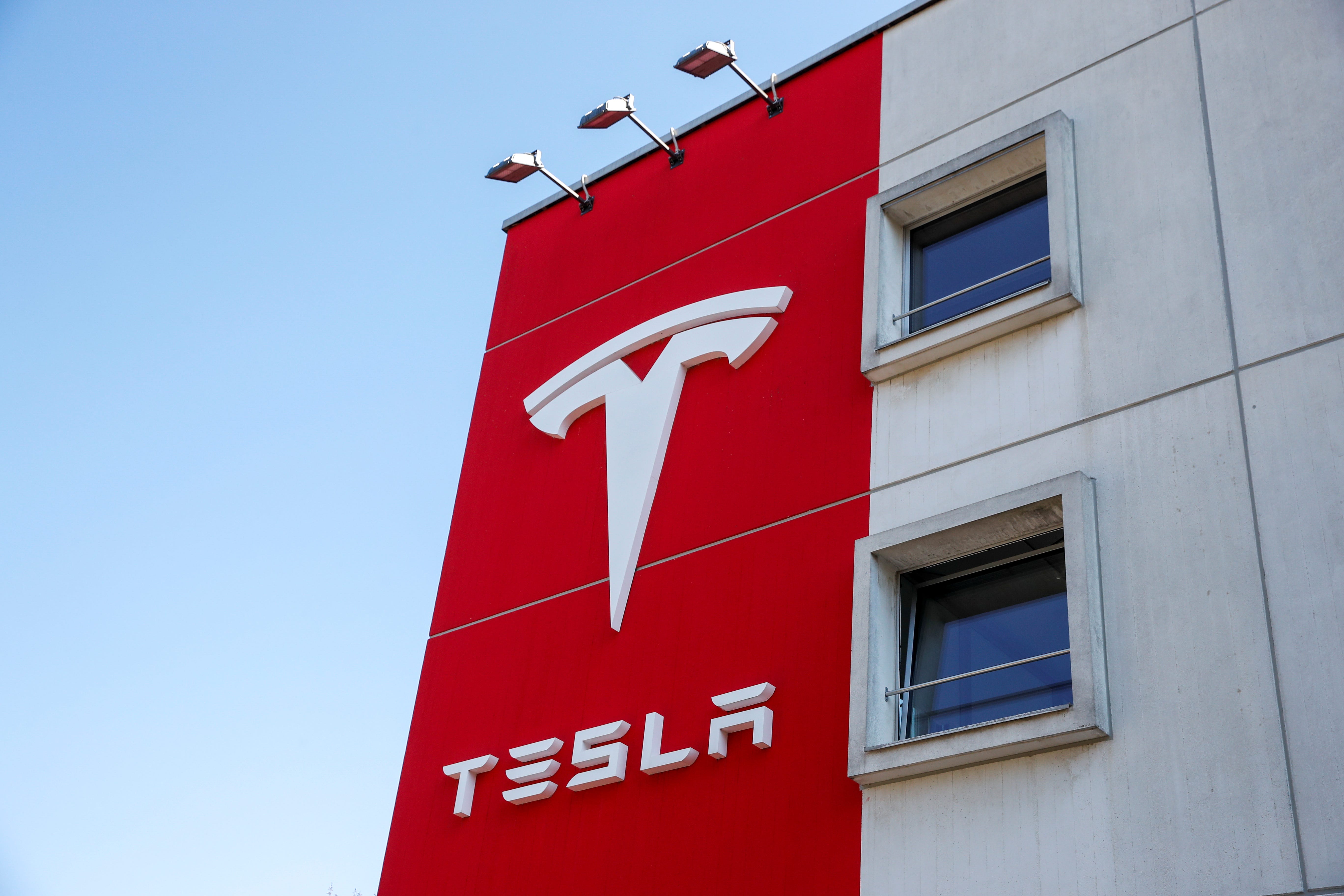 FILE PHOTO: The logo of Tesla is seen at a branch office in Bern, Switzerland March 25, 2020. REUTERS/Arnd Wiegmann/File Photo
