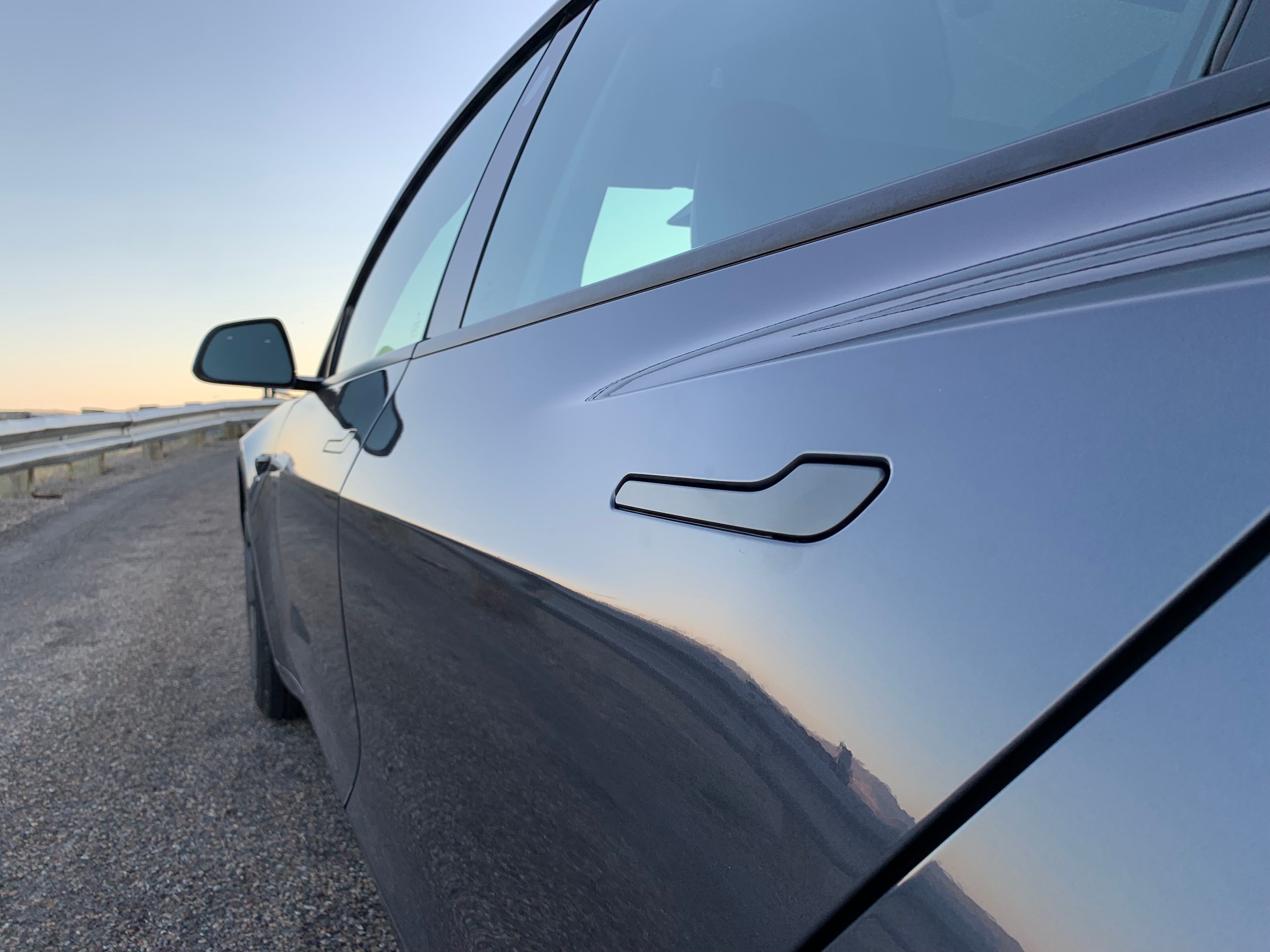 An up-close photo of a Tesla door handle.