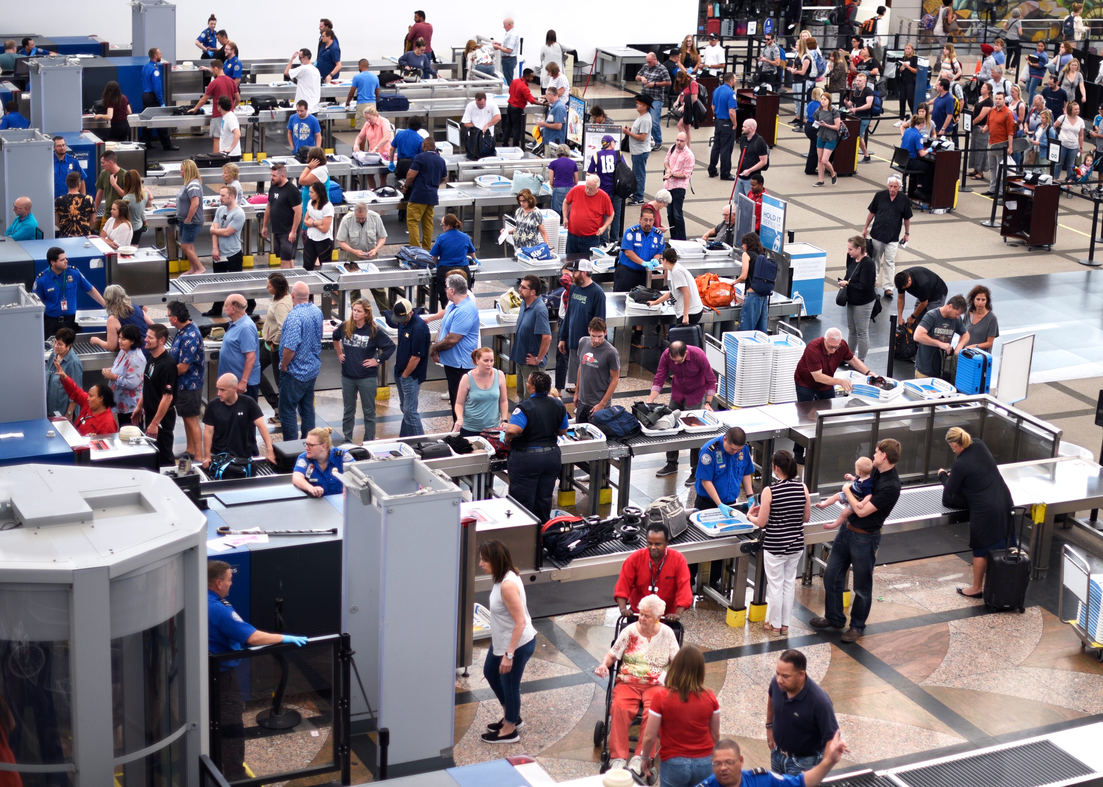 Lines of airplane passengers proceed through the TSA security checkpoint at Denver International Airport in Denver, Colorado.