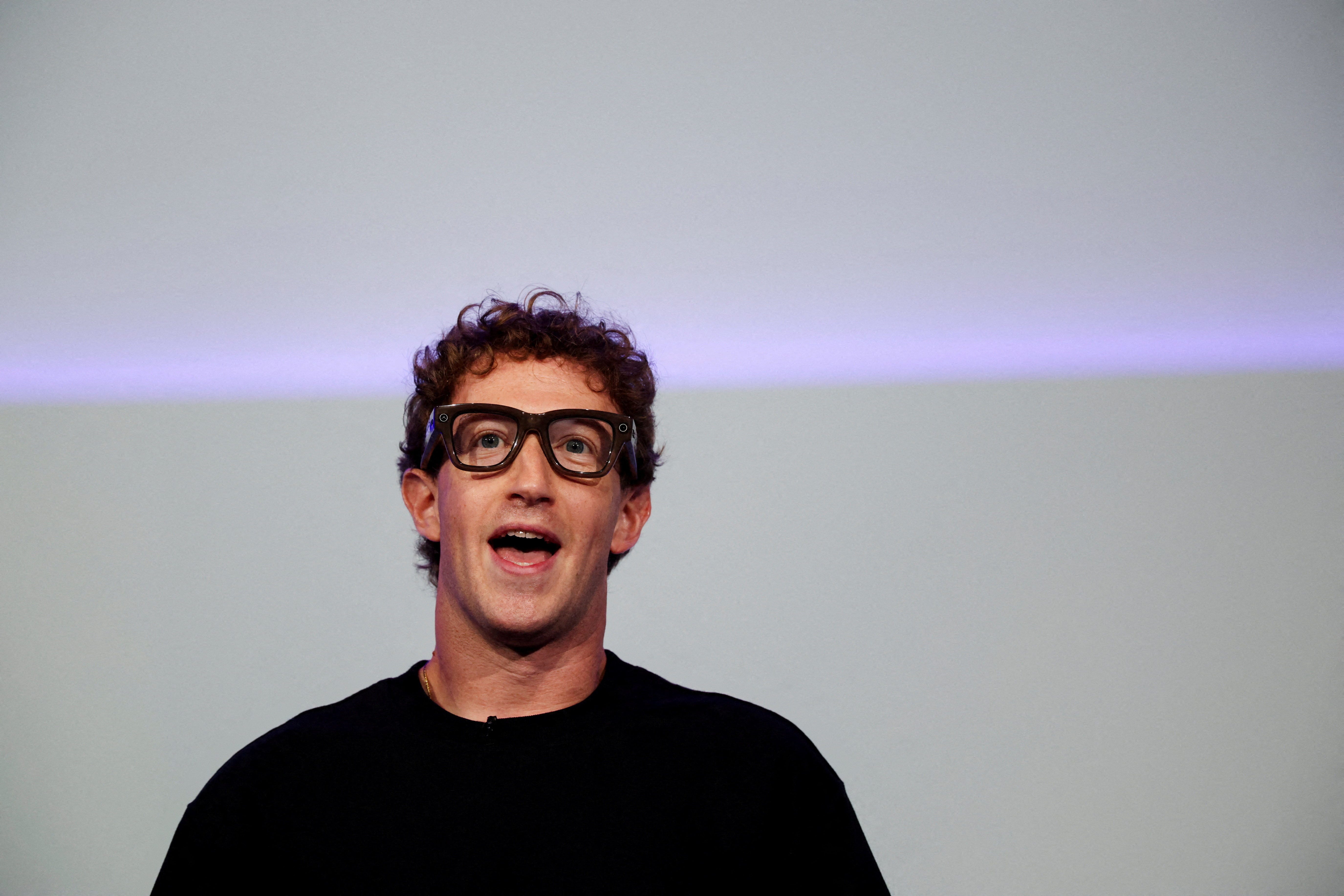Meta CEO Mark Zuckerberg wears the Meta Ray-Ban Display glasses, as he delivers a speech presenting the new line of smart glasses, during the Meta Connect event at the company's headquarters in Menlo Park, California, U.S., September 17, 2025. REUTERS/Carlos Barria