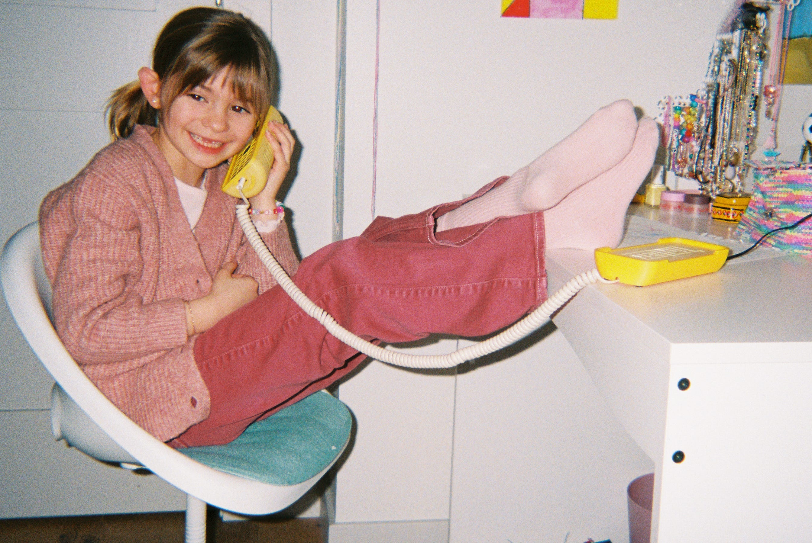 young girl on a landline style phone