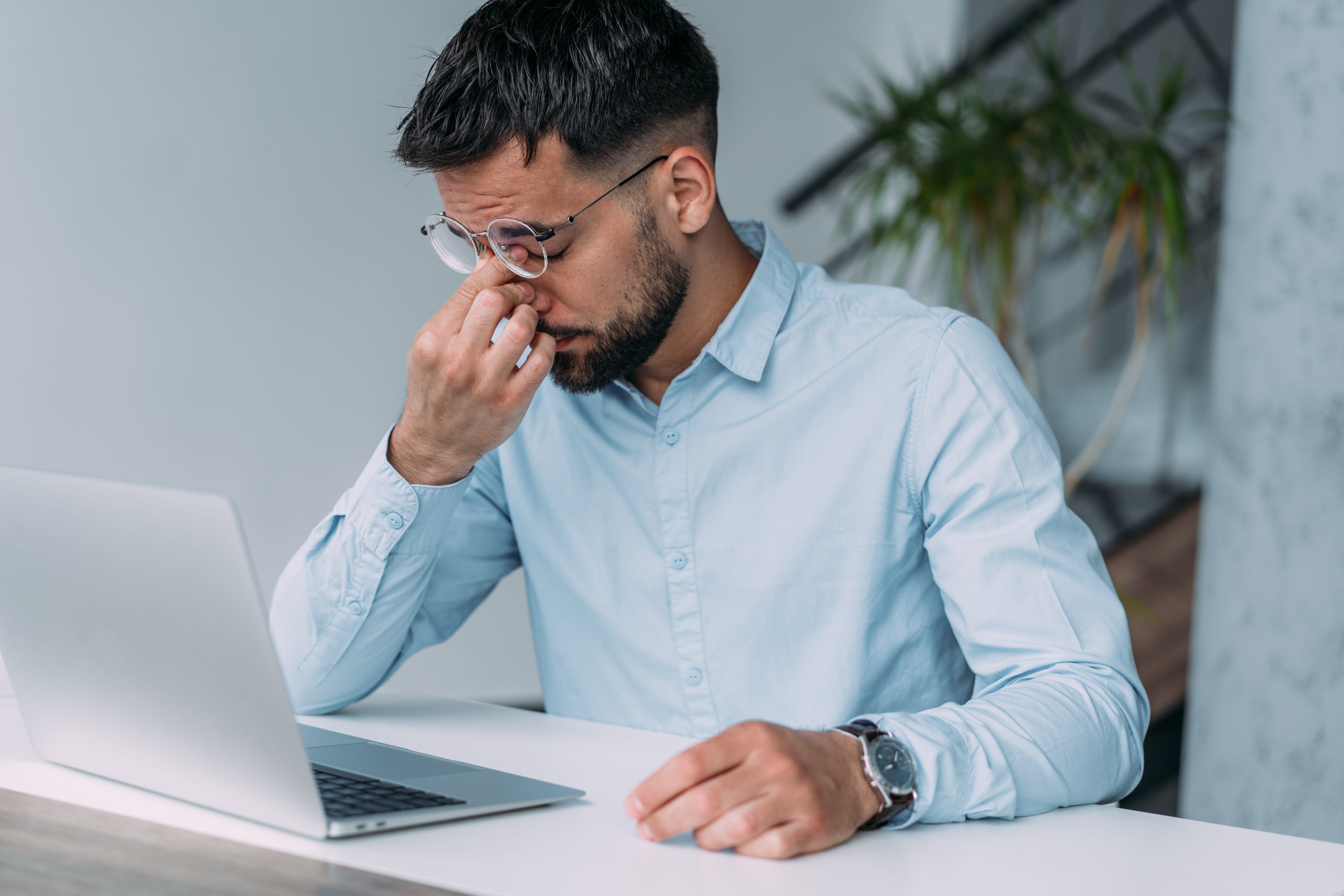 man on laptop looking stressed