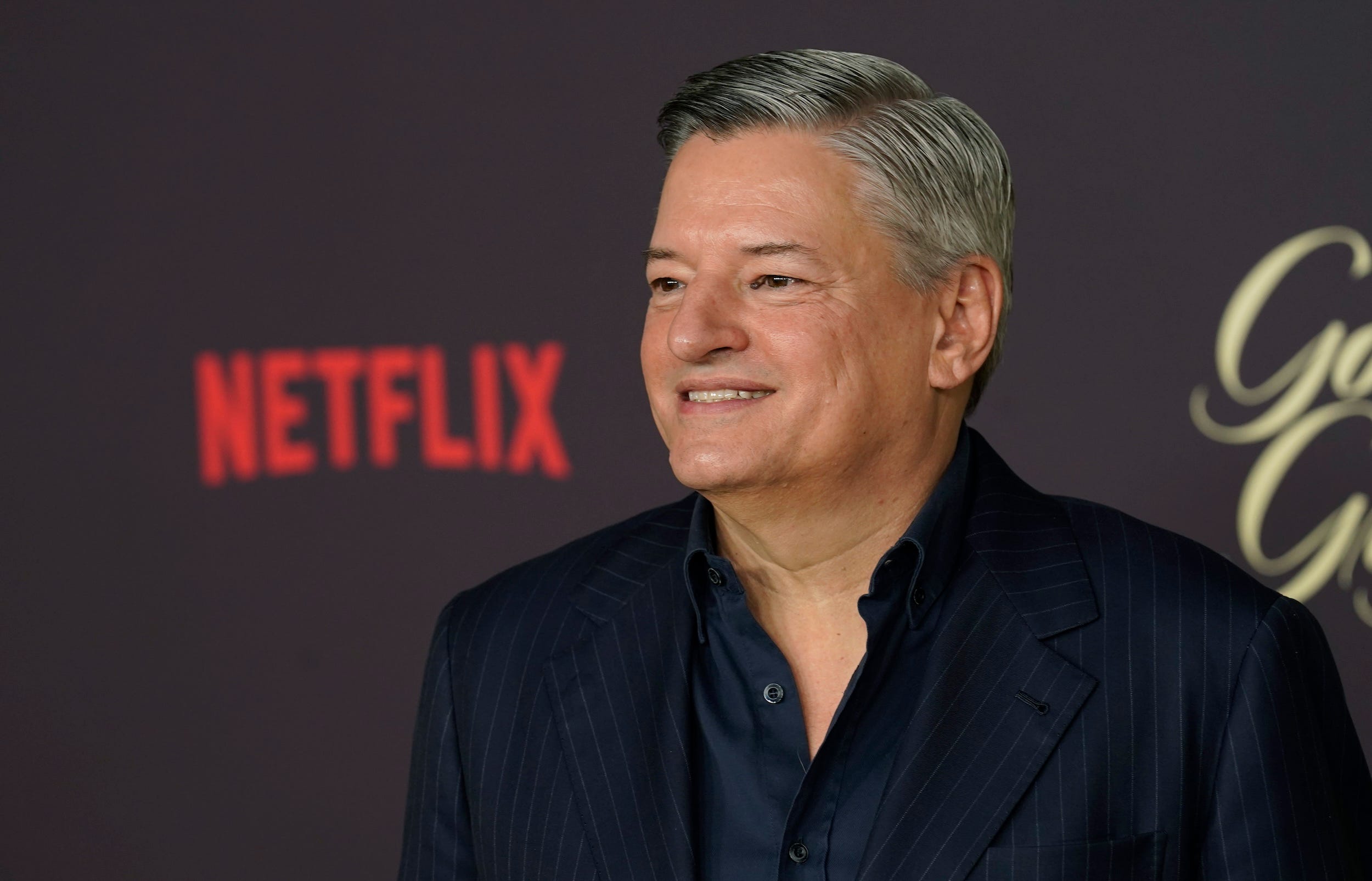 Ted Sarandos poses on the red carpet of a Netflix fim premiere
