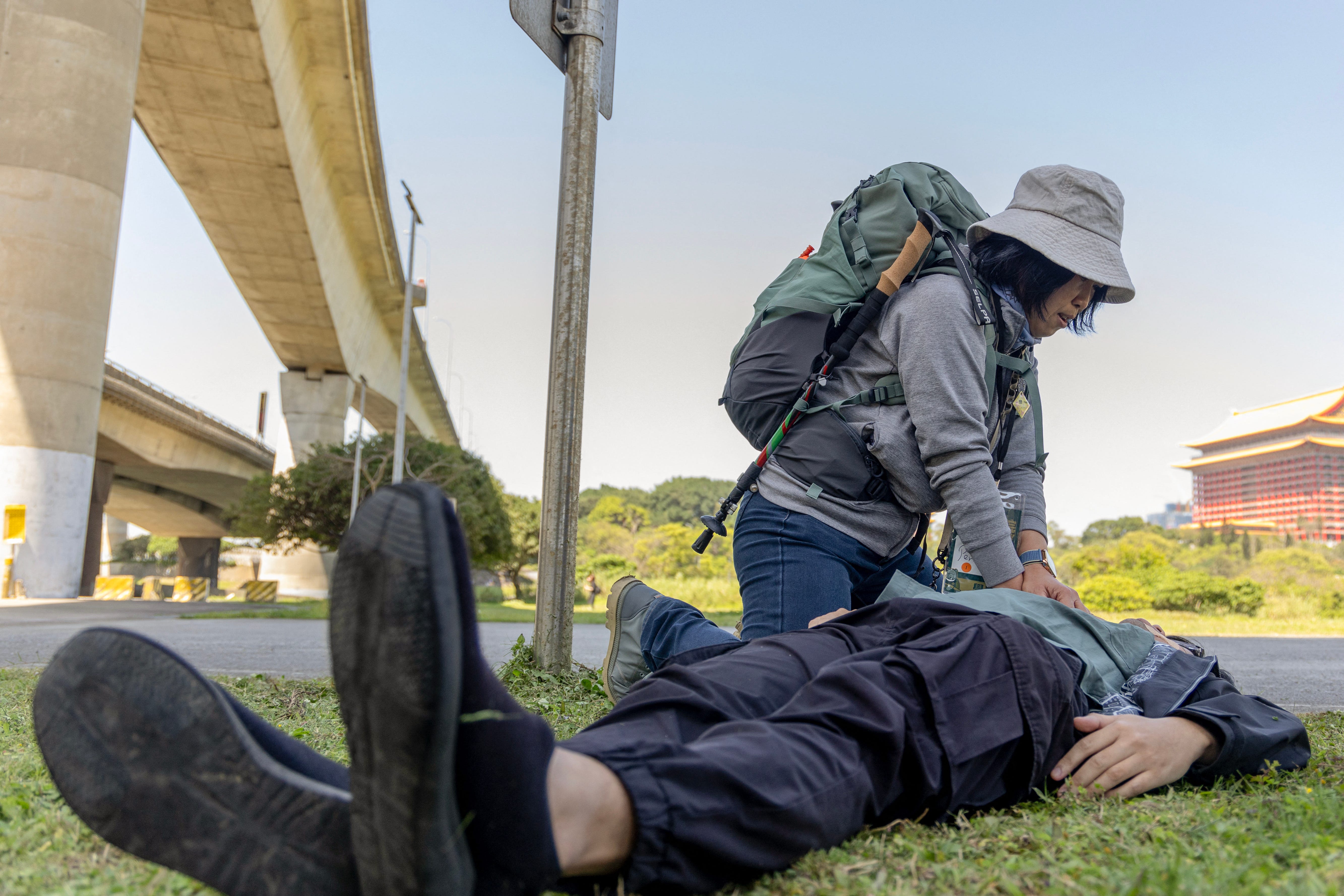 Participants give CPR to a make-believe injured person during a civil defense course at Kuma Academy in Taipei.