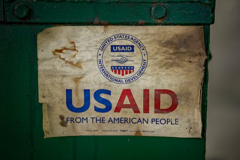 MANILA, PHILIPPINES - MARCH 10: The USAID logo is seen on a machine that processes recycled plastic into construction blocks at the Pasig Eco Hub, a project impacted by the Trump administration's freeze on foreign aid, on March 10, 2025 in Pasig, Metro Manila, Philippines. The recent suspension of USAID funding by the Trump administration has resulted in the loss of at least $69.7 million (approximately PHP 4.06 billion) in aid programs across the Philippines, affecting 39 ongoing projects spanning environmental conservation, health initiatives, disaster response, and education—some of which were set to continue until 2029. Among the impacted projects is the Pasig Eco Hub, a USAID-funded waste management facility, which shut down due to financial constraints, with USAID funding cuts further disrupting its recycling and sustainability programs. (Photo by Ezra Acayan/Getty Images)