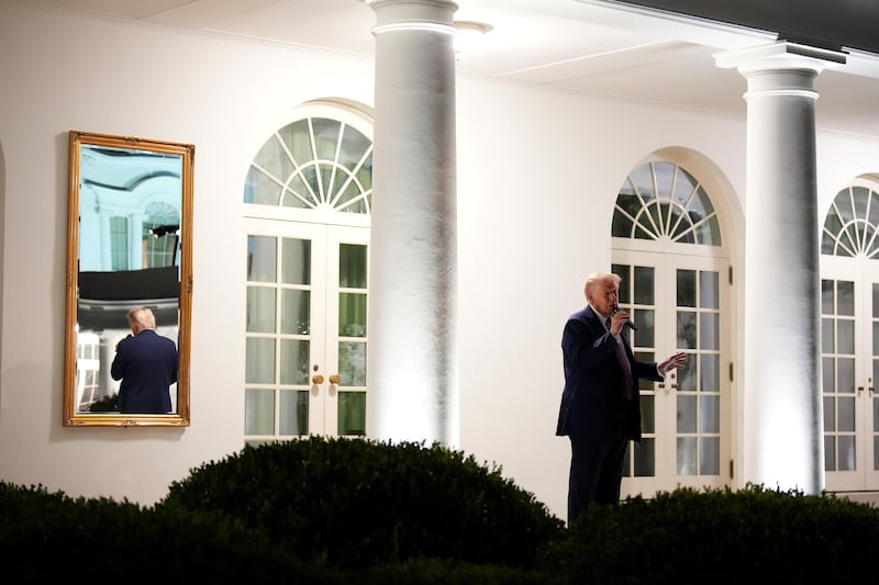 Donald Trump addresses members of Congress as hosts them for dinner in the Rose Garden at the White House.