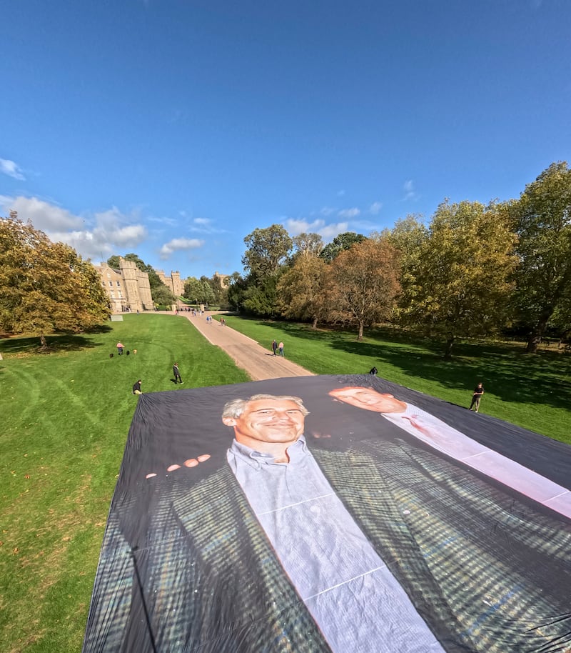 The giant poster was placed on the grounds of Windsor Castle.