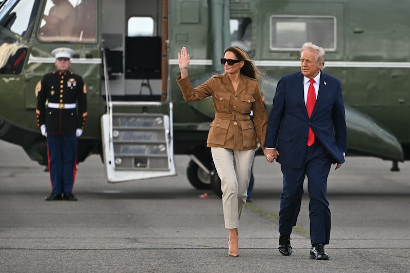 President Donald Trump and First Lady Melania Trump walk across the tarmac toward Air Force One at Stansted Airport, in Stansted on September 18, 2025.