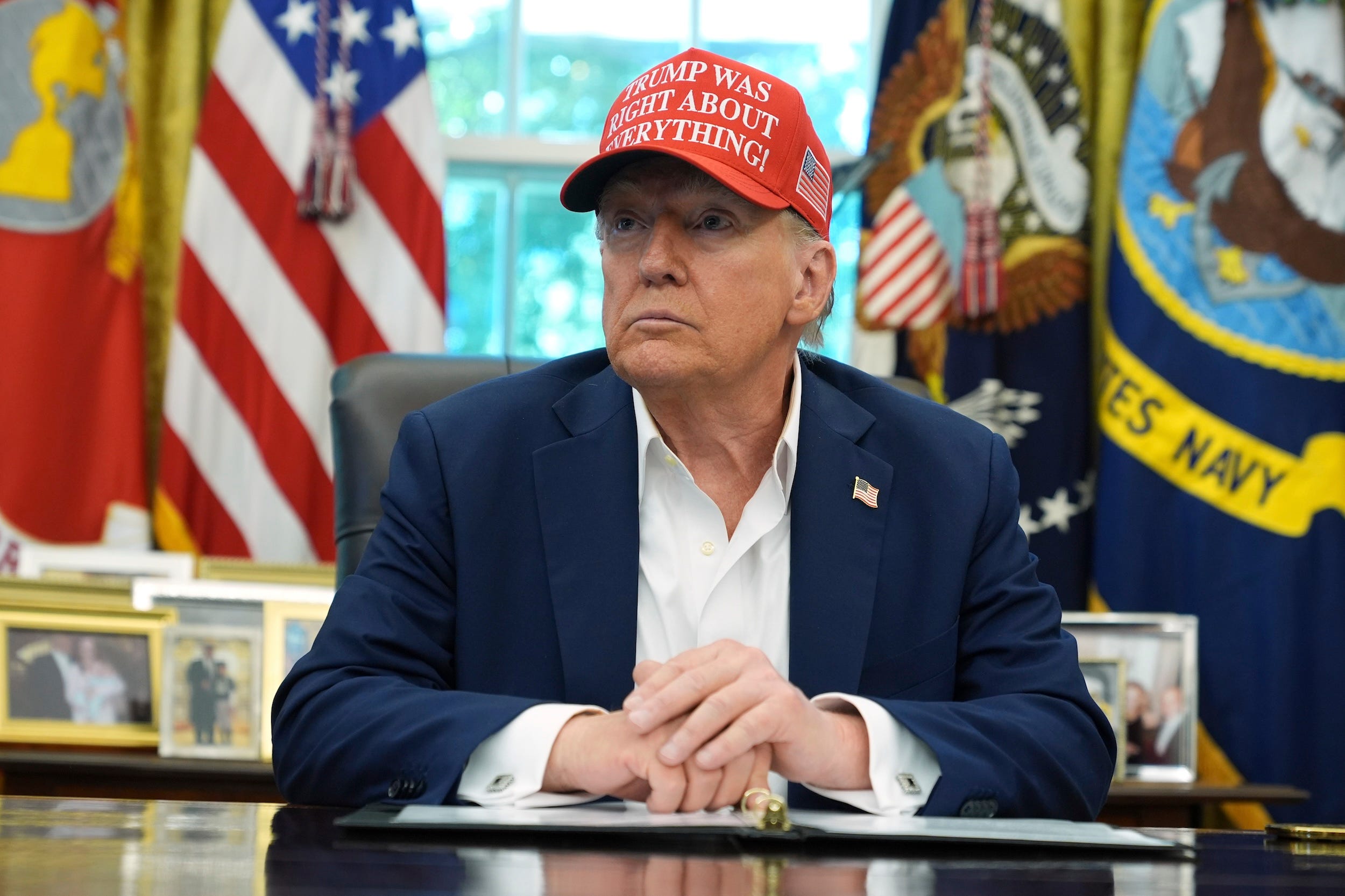 Donald Trump looks at reporters in the Oval Office