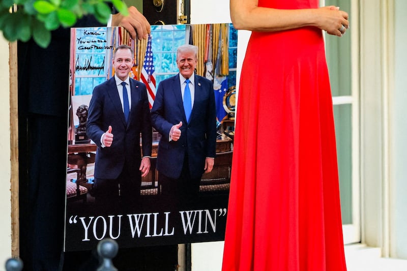 A poster with images of President of Poland Karol Nawrocki and U.S. President Donald Trump is carried, following the presidents' meeting at the White House in Washington, D.C., U.S., September 3, 2025.  REUTERS/Brian Snyder     TPX IMAGES OF THE DAY