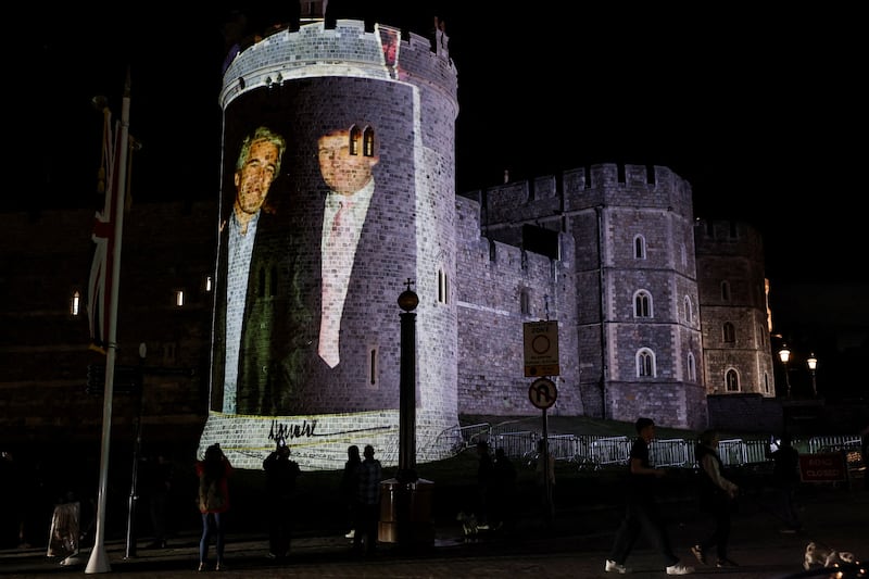 An image of U.S. President Donald Trump alongside disgraced financier Jeffrey Epstein is projected on Windsor castle, after U.S. President Donald Trump and first lady Melania Trump arrival for a state visit to the country, in Windsor, Berkshire, Britain September 16, 2025. REUTERS/Phil Noble     TPX IMAGES OF THE DAY