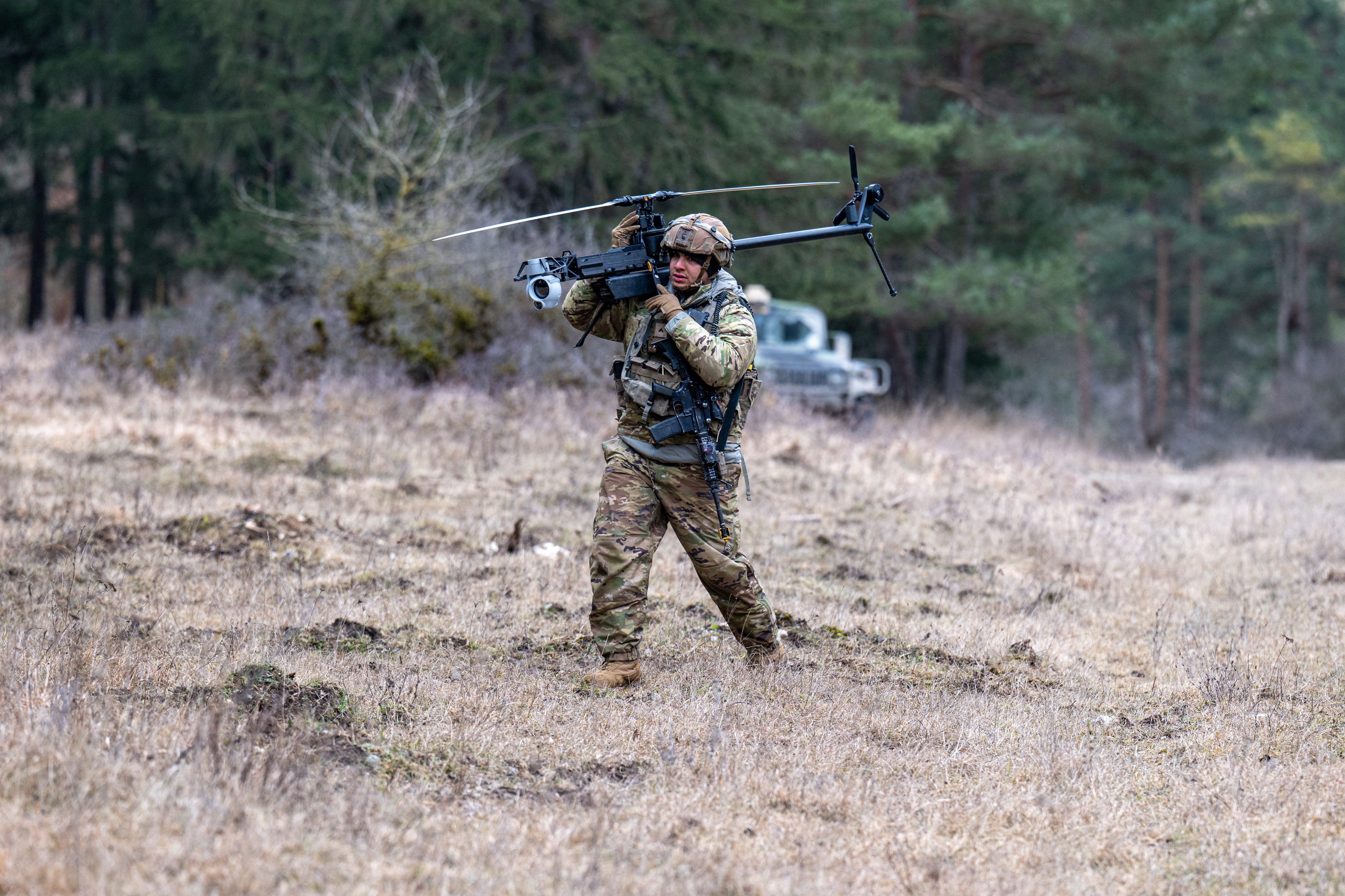 A US soldier carries an Anduril Ghost X drone in Germany in February 2025.
