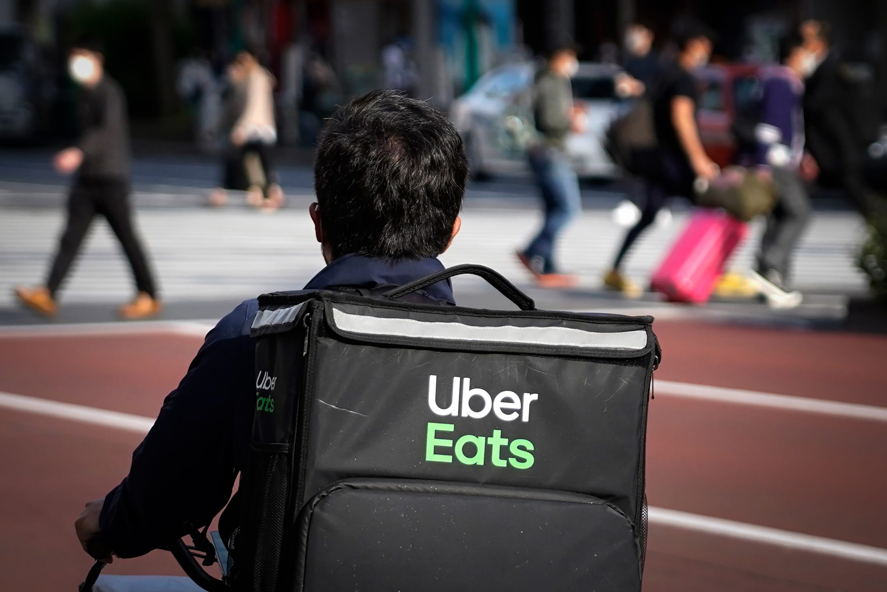 Uber Eats driver on the job while moving through a busy city street.