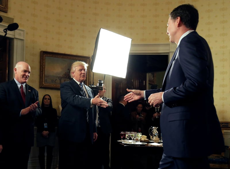 James Comey, right, towered over President Donald Trump when the two met in the White House’s “Blue Room” in 2017.