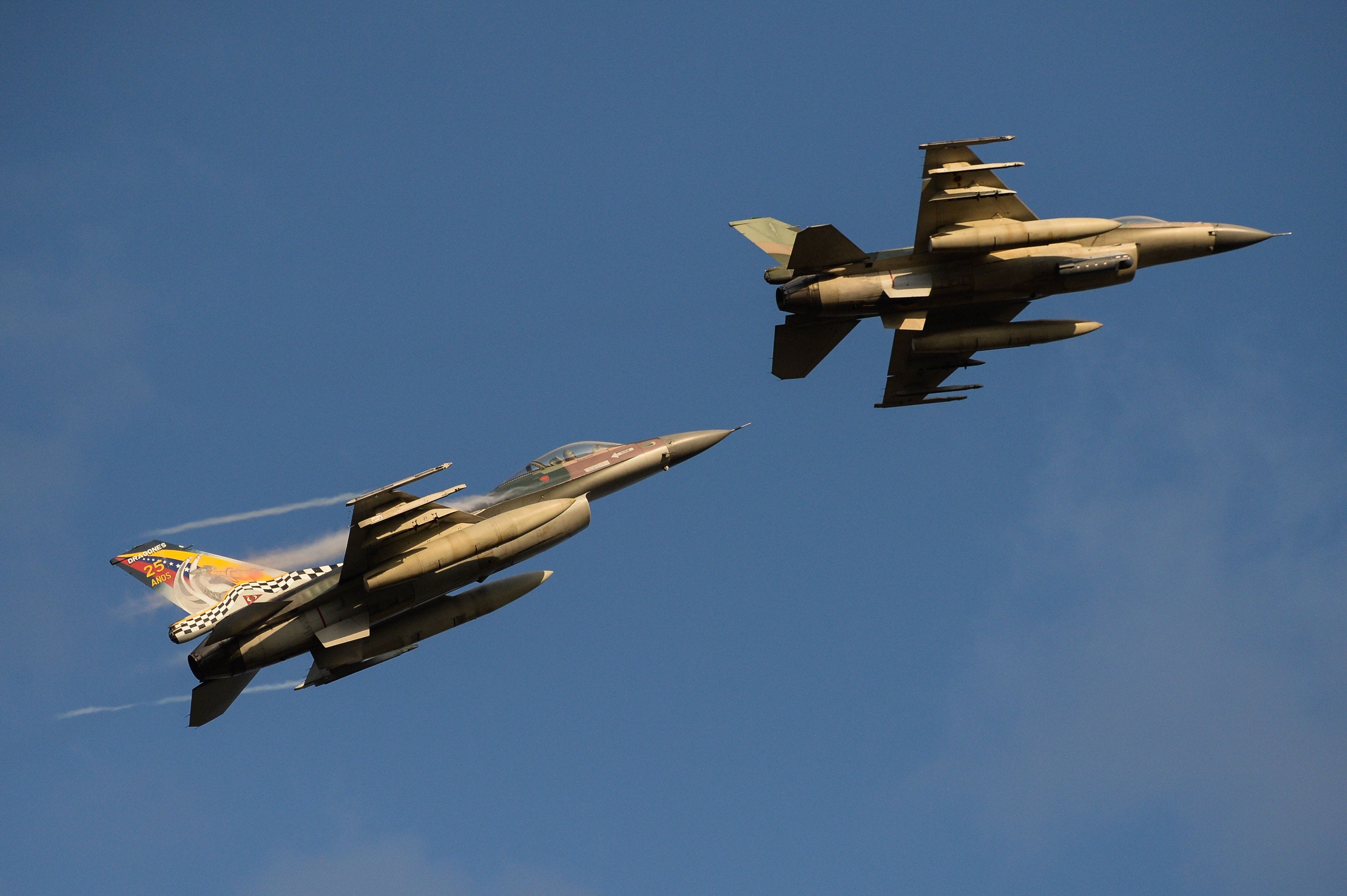 F-16 aircrafts of the Venezuelan Air Force overfly during a military parade to commemorate the 16th anniversary of the return of the late President Hugo Chavez to power after a failed coup d' etat, at the National Heros Avenue in Caracas on April 13, 2018.