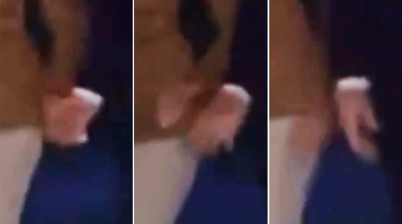 A sequence of frame grabs showing Melania Trump, left, pulling her hand away from Donald Trump.