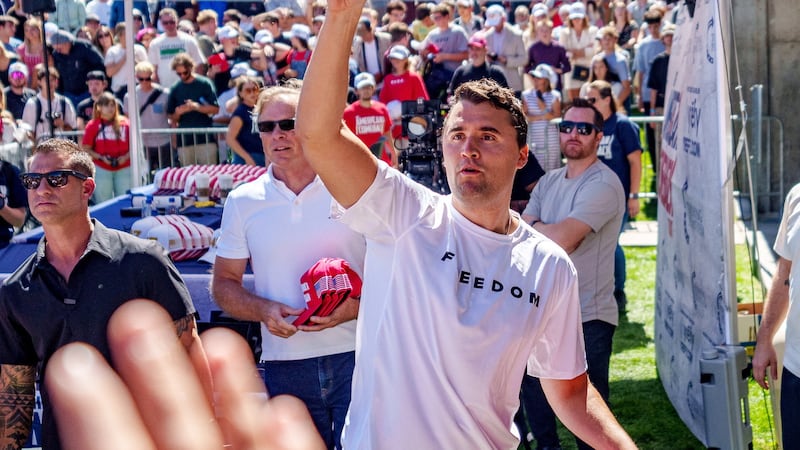 Right-wing activist and commentator Charlie Kirk throws hats to the crowd shortly before he was shot at a Utah Valley University speaking event in Orem, Utah, Sept. 10, 2025.