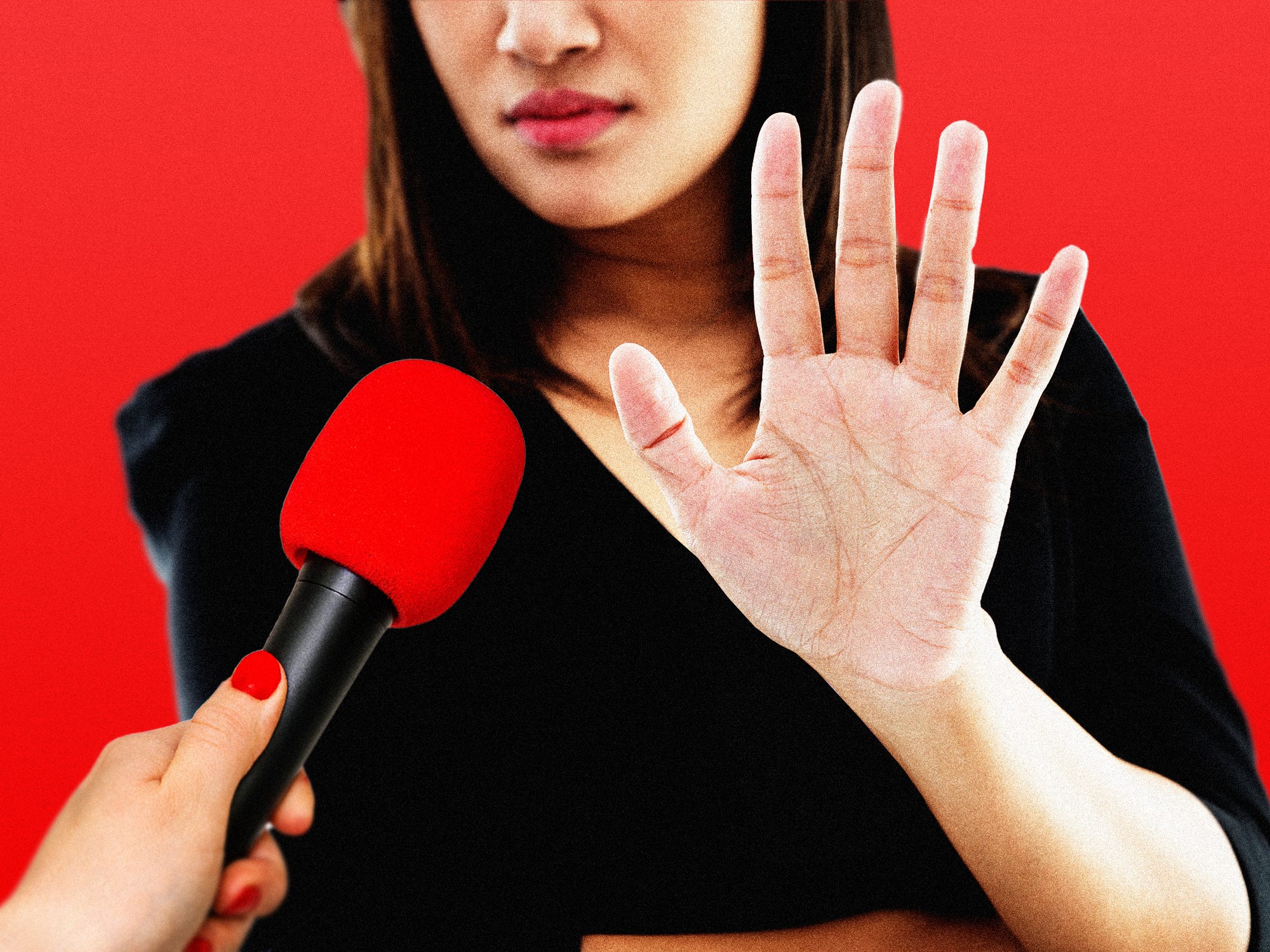 A business woman declining a microphone