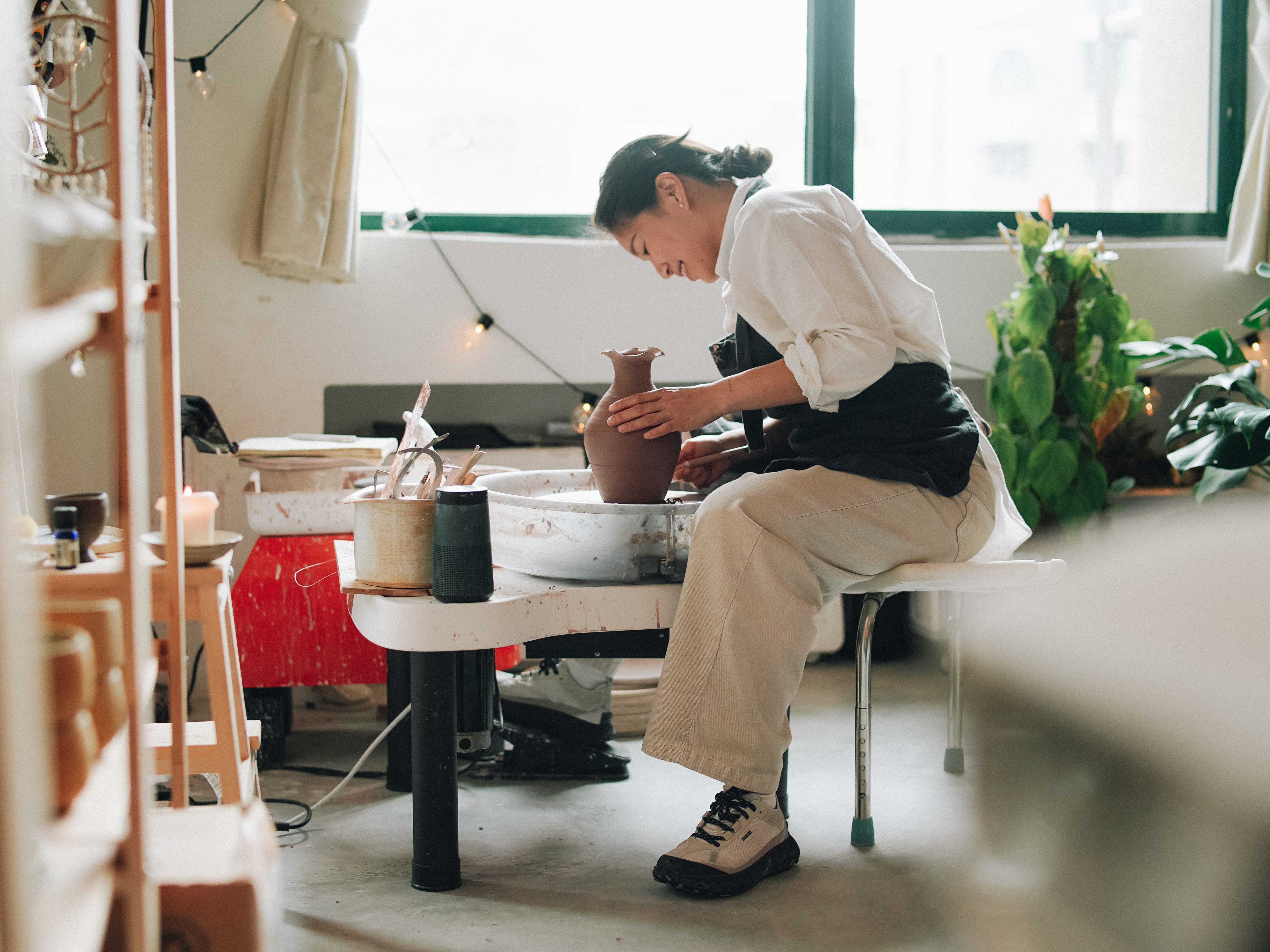 A woman working at the pottery wheel.