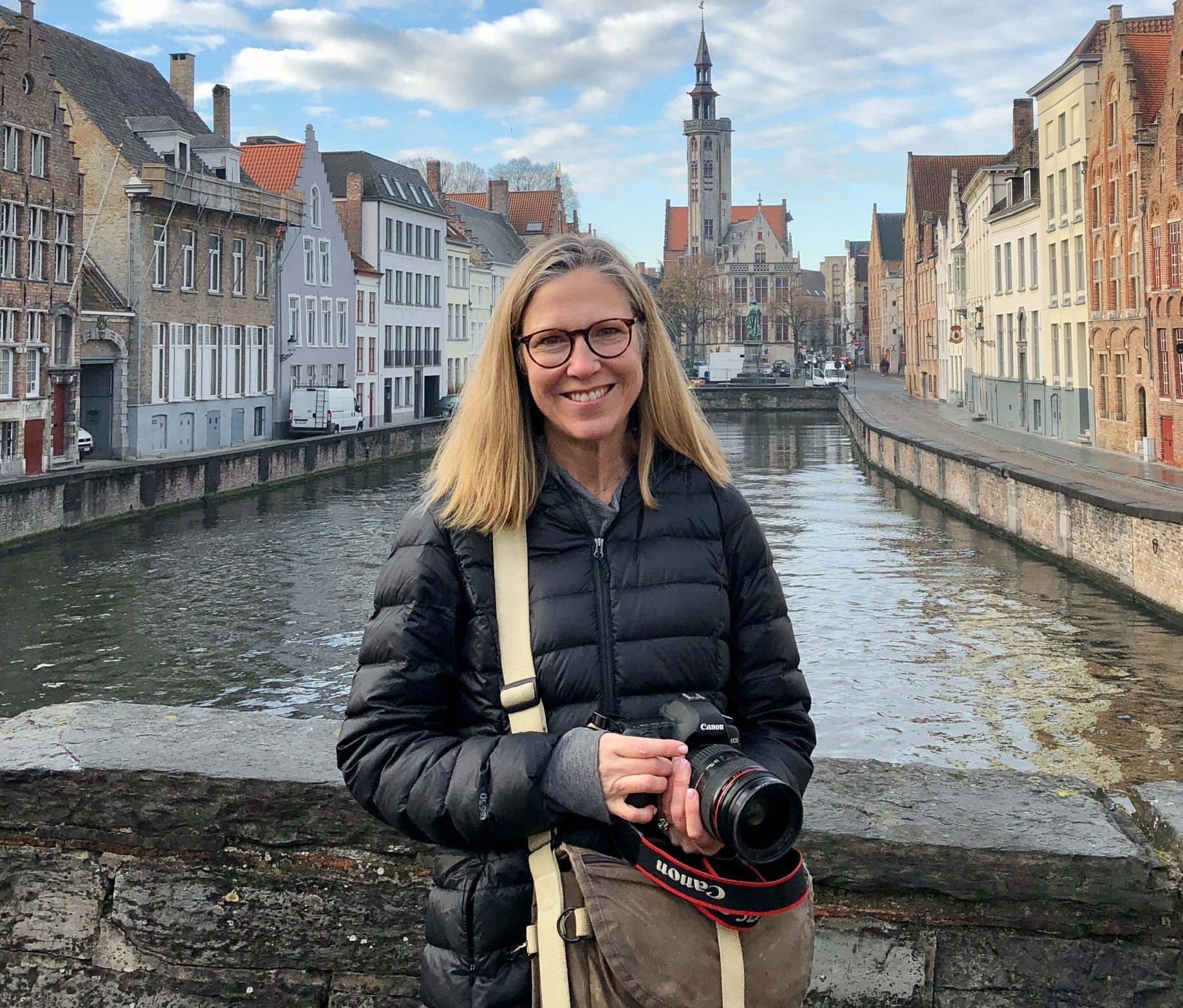 Lisa VanderVeen on a bridge with a camera.