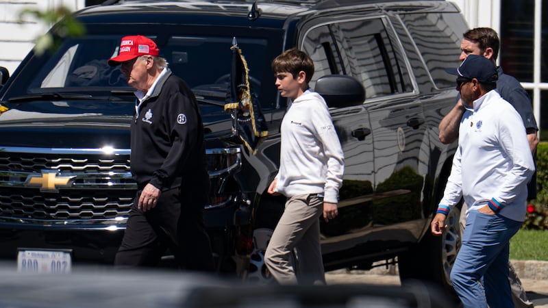 WASHINGTON, DC - AUGUST 30: U.S. President Donald Trump walks with his grandchild Spencer Trump after golfing at Trump National Golf Club on August 30, 2025 in Washington, DC. Trump is spending his Labor Day weekend in Washington, DC after deploying the National Guard to Washington this month. (Photo by Kayla Bartkowski/Getty Images)