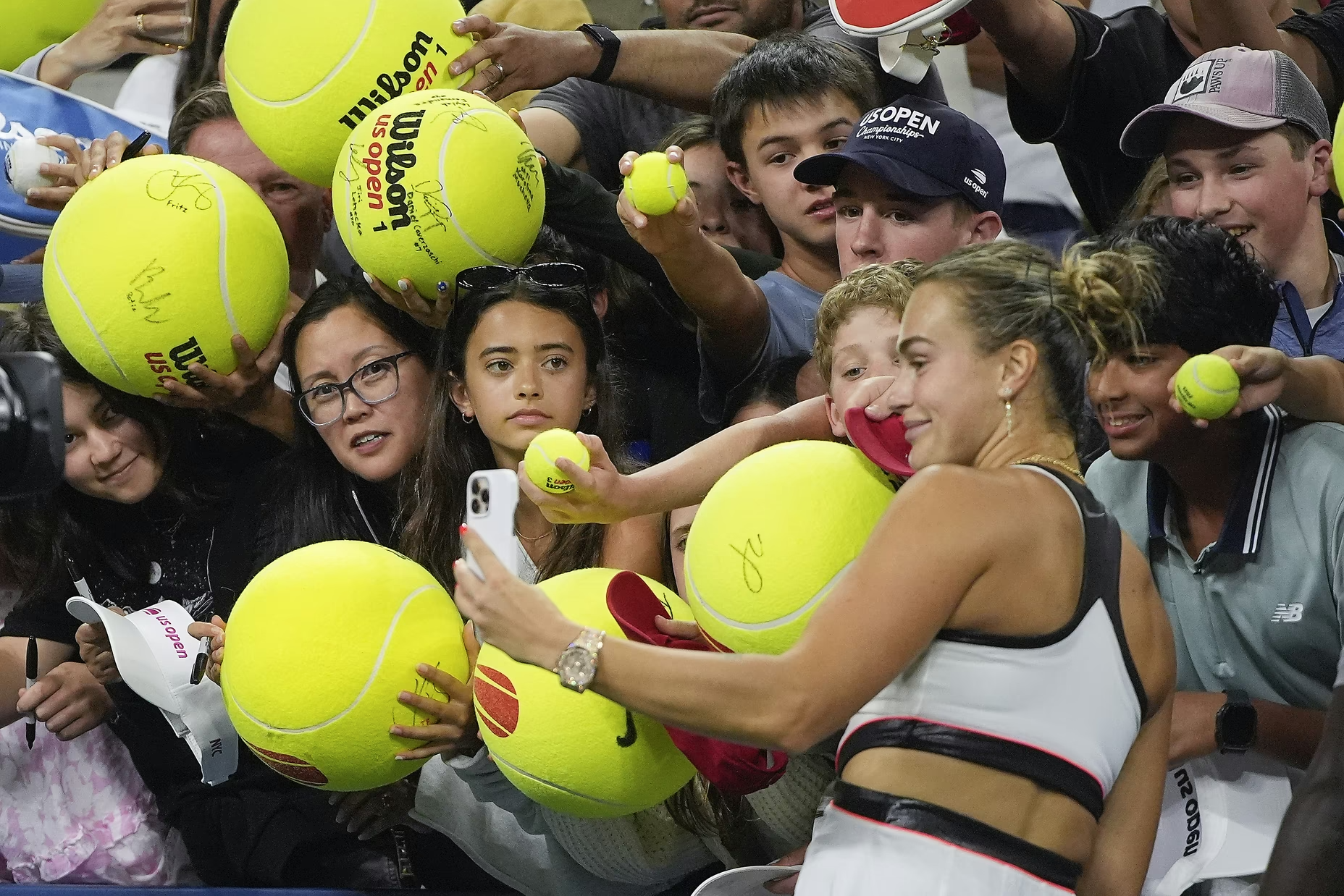 Aryna Sabalenka of Belarus takes photos with fans after defeating Spain’s Cristina Bucsa during the fourth round of the U.S. Open tennis championships, on August 31, 2025, in New York.