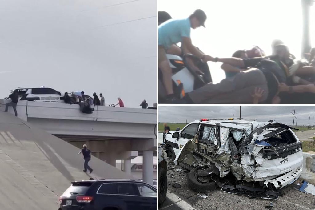 Wild video shows sheriff’s deputy dangling from bridge after truck totals his squad car