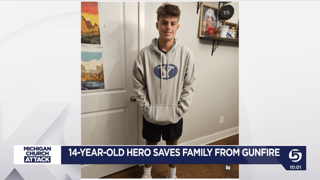 A 14-year-old boy in a grey hoodie.