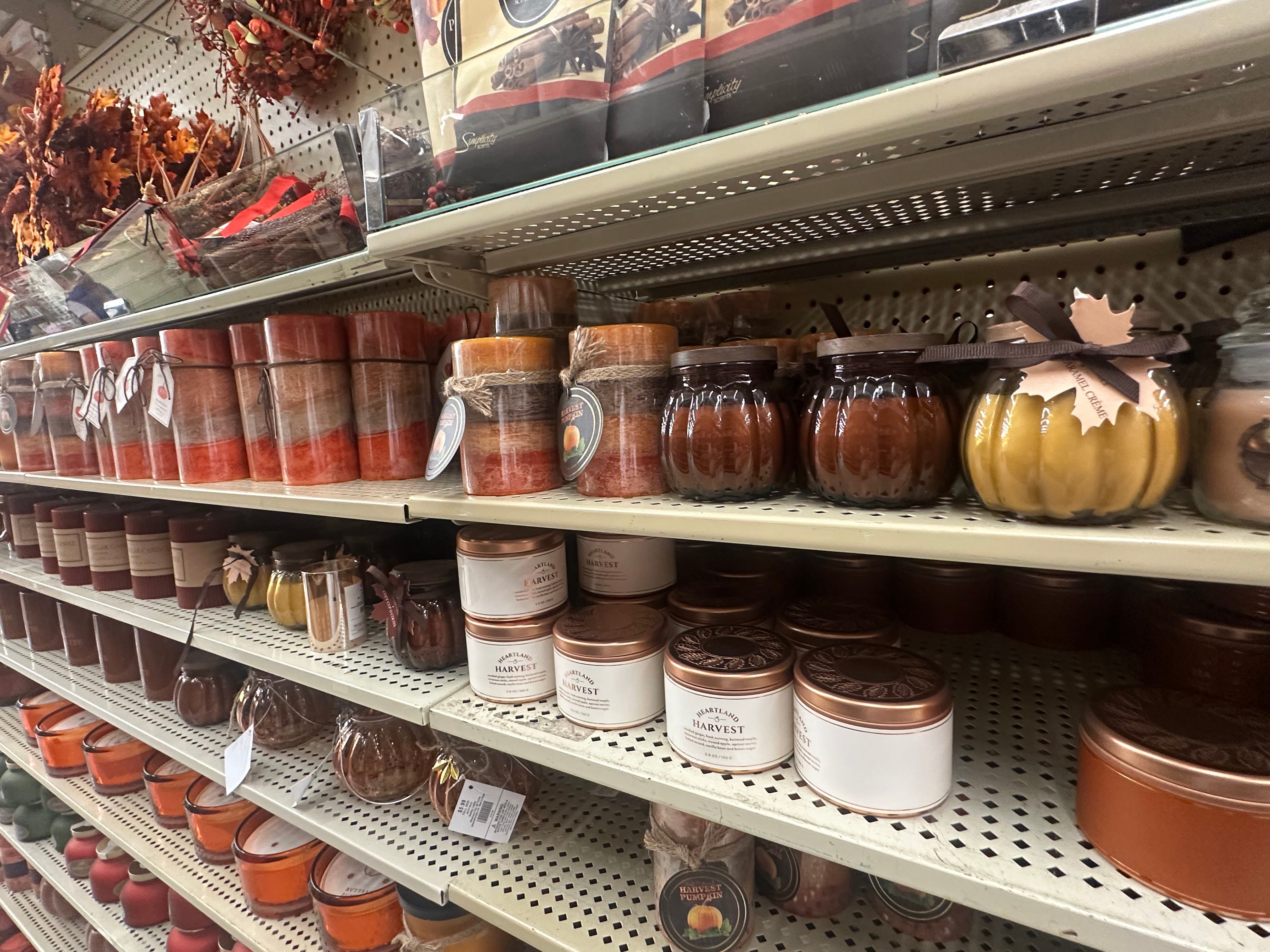 Orange, brown, gold autumnal candles on shelf in Hobby Lob