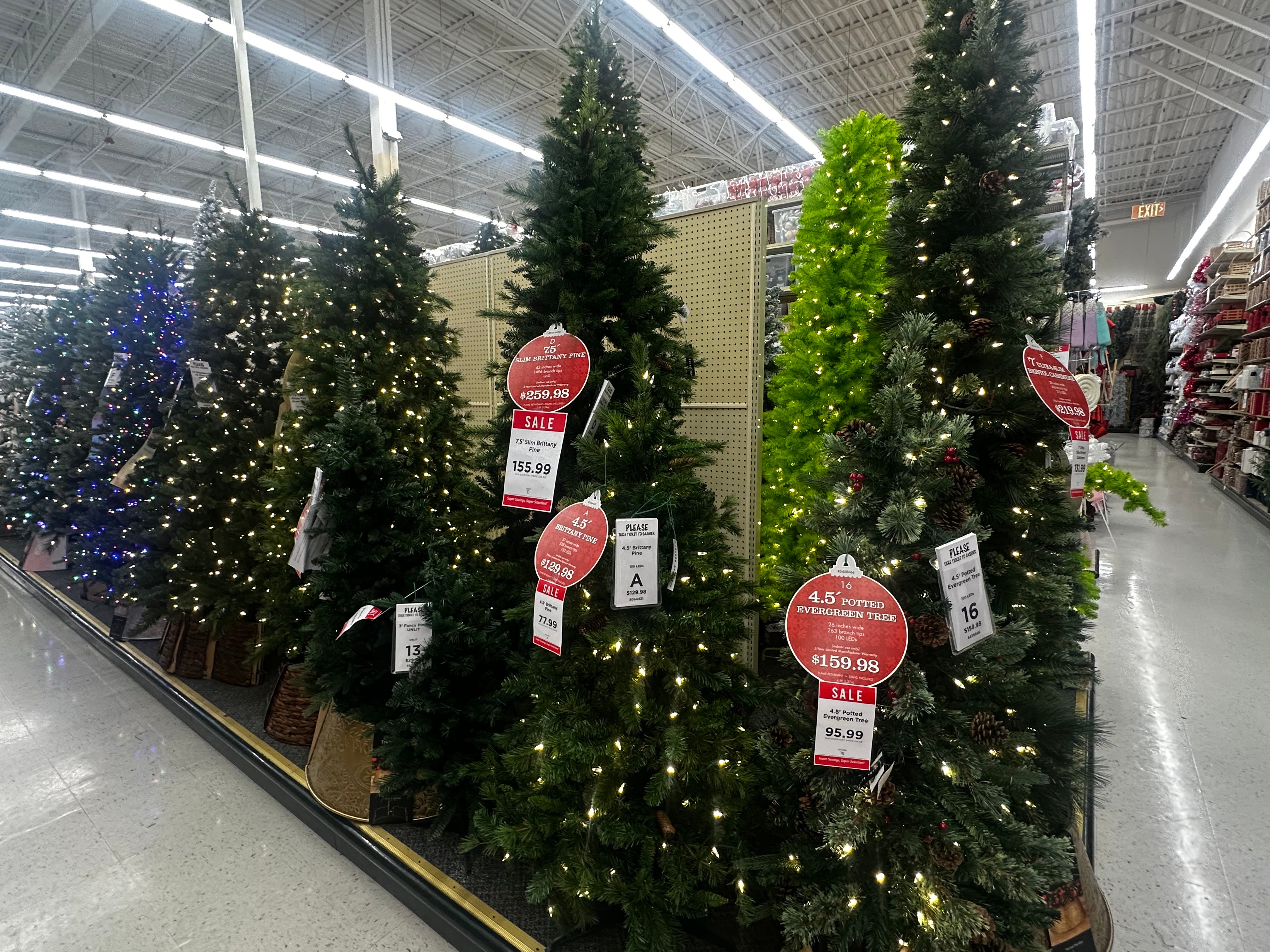 Christmas trees with lights on display at Hobby Lobby