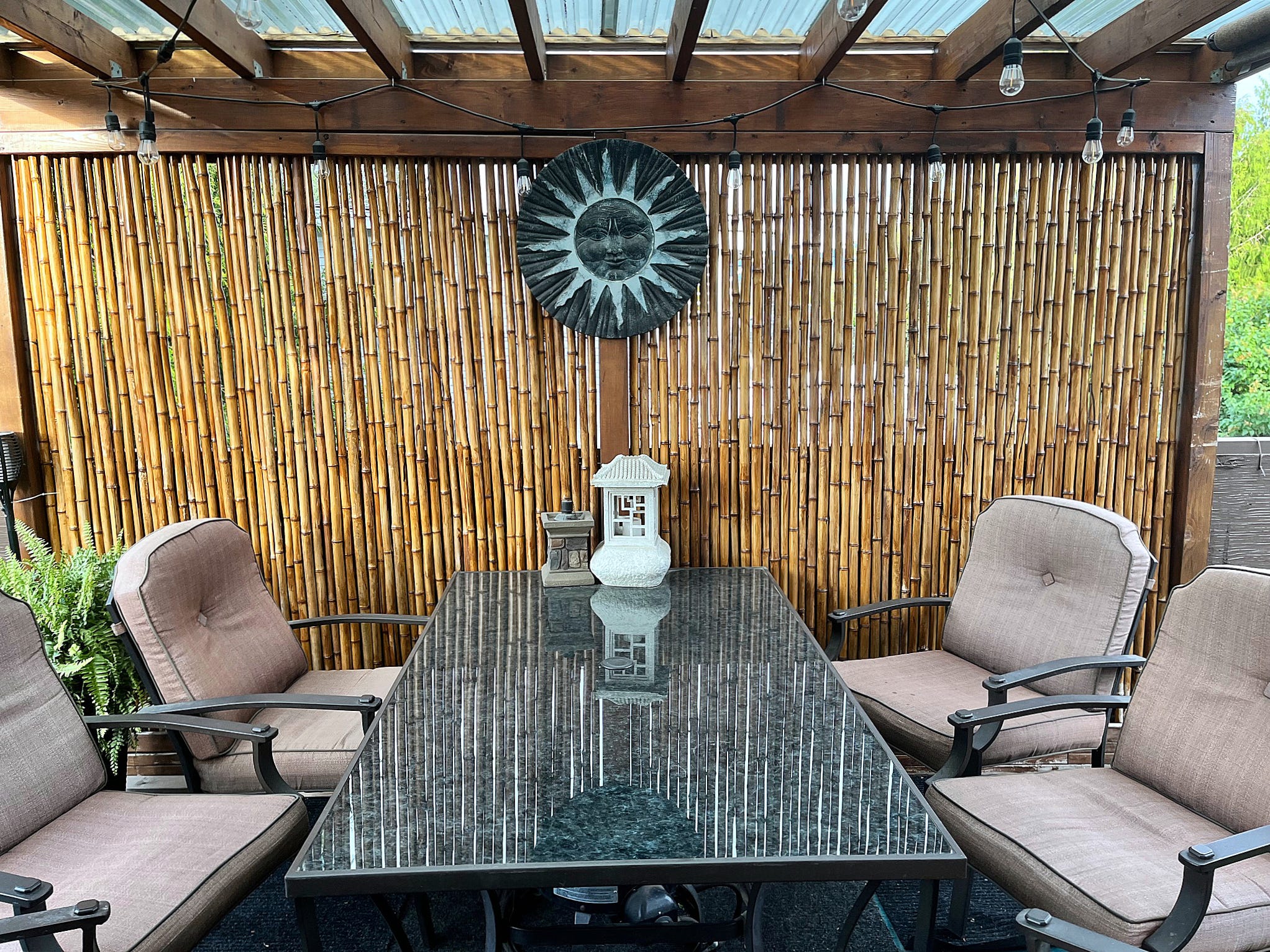 Outdoor space with table, chairs, bamboo curtain