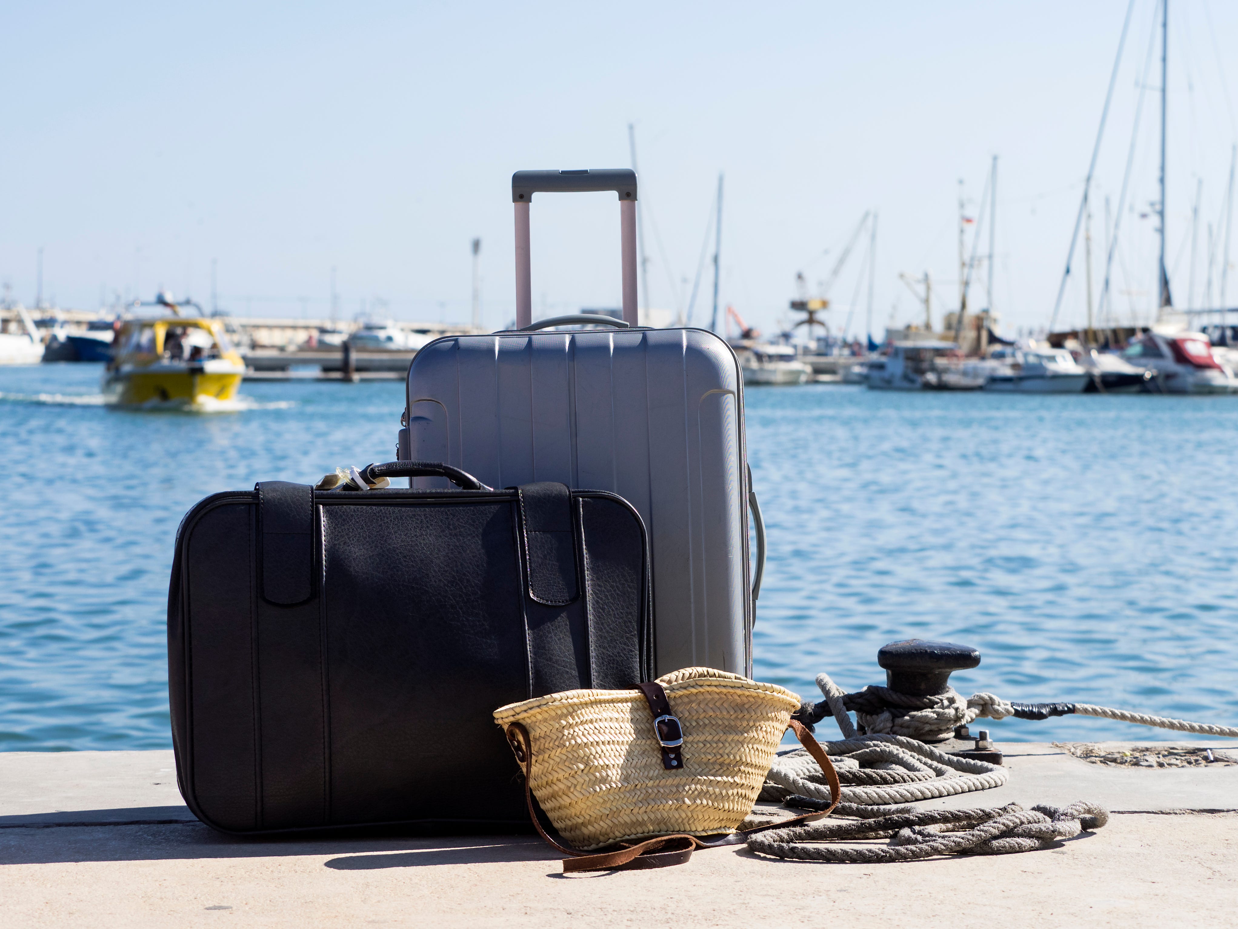 Luggage on a dock near the water.