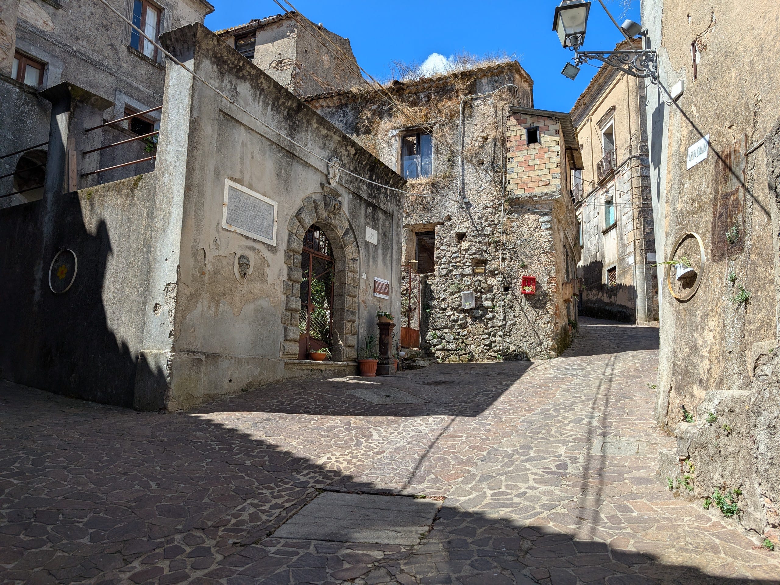 Stone-covered street with stone buildings next to it