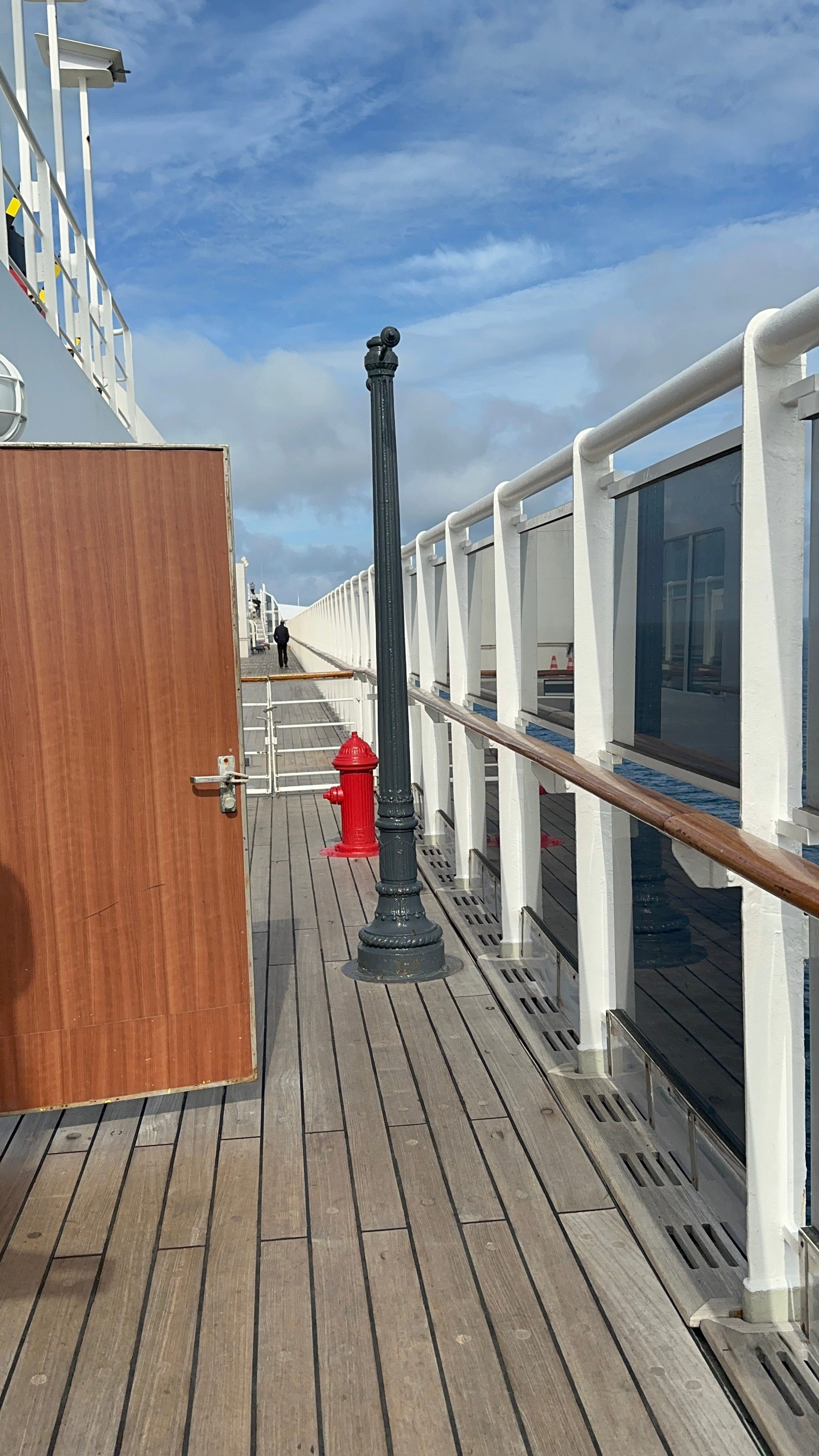A fire hydrant and lamp post sit next to each other on a cruise deck.