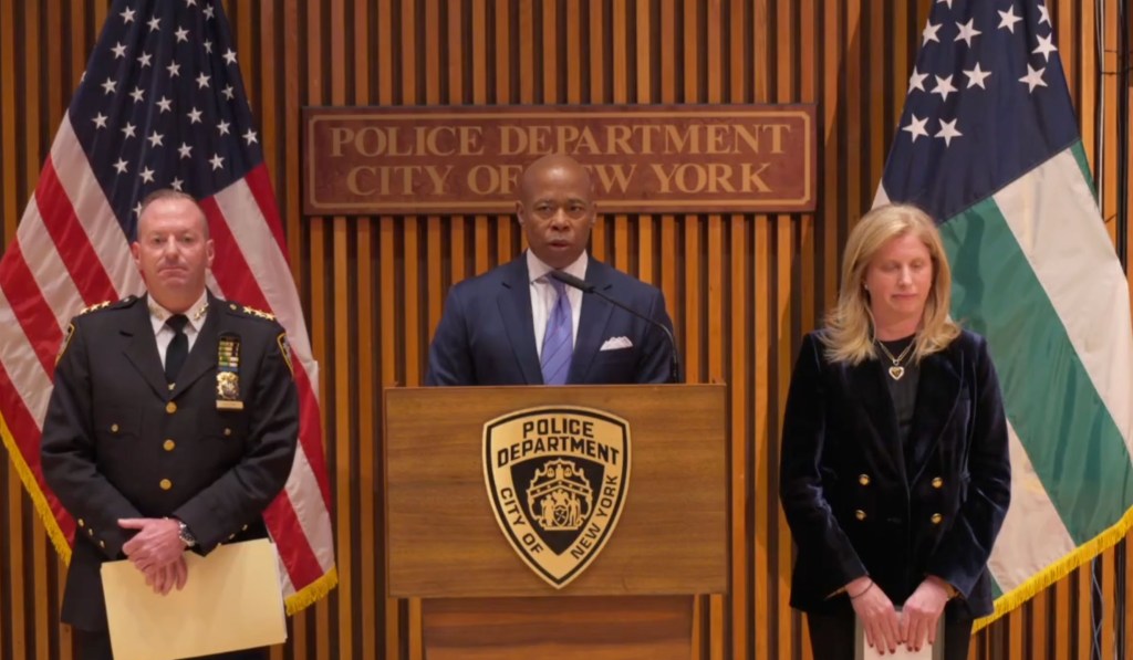 Mayor Eric Adams speaks at a lectern.