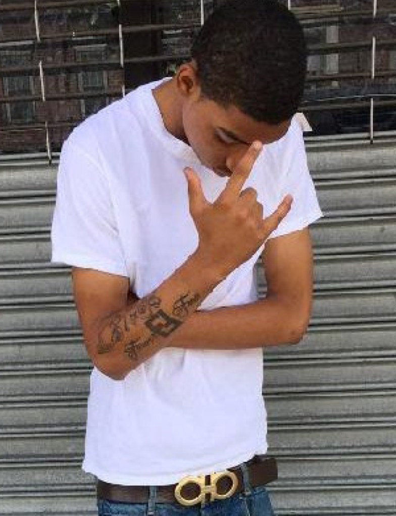 Elijah Roy, member of the Bloods gang, making a gang sign.